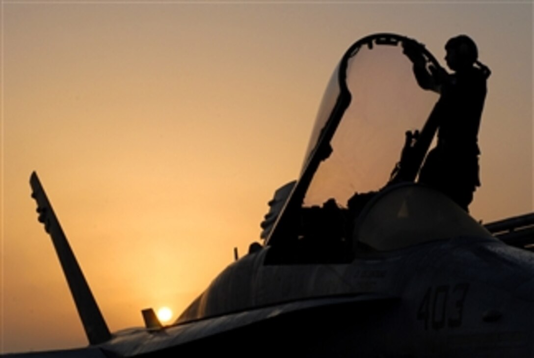 U.S. Navy Petty Officer 3rd Class Kyle Alhers wipes off the condensation on the canopy of an F/A-18C Hornet aircraft of Strike Fighter Squadron 25 on the flight deck of the aircraft carrier USS Ronald Reagan (CVN 76) while underway in the Gulf of Oman on Oct. 14, 2008.  The Reagan is deployed to the U.S. 5th Fleet area of responsibility.  