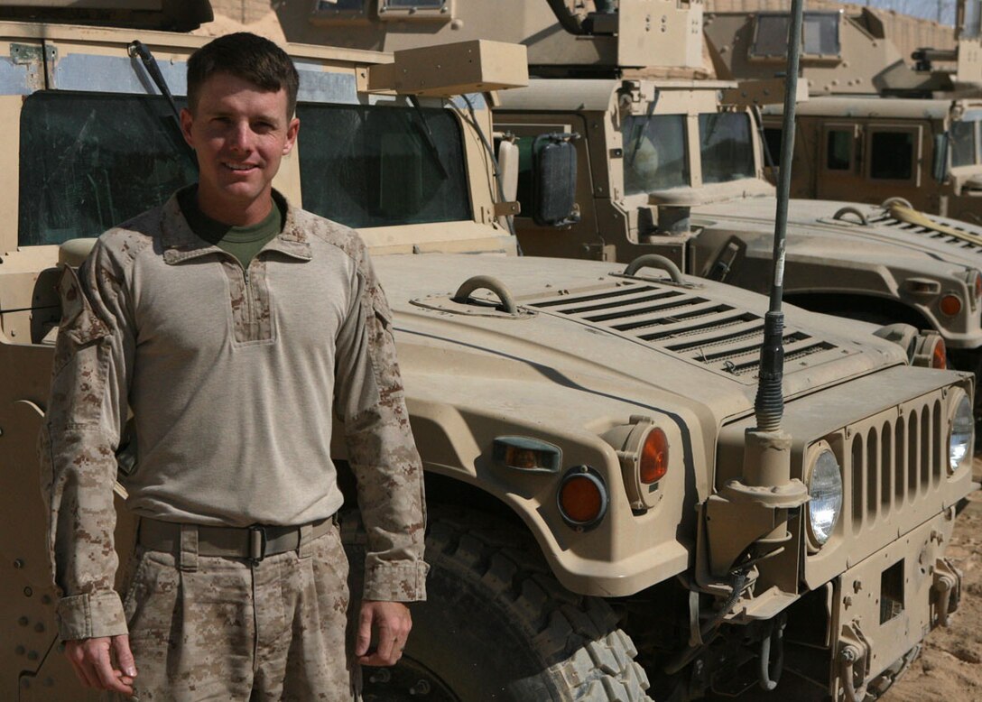 Sgt. Dustin Baker, a vehicle commander with Civil Affairs Team 6, Detachment 1, 2nd Battalion, 11th Marine Regiment, Regimental Combat Team 5, poses for a photograph at Haqlaniyah, Iraq, Oct. 14. Baker is an individual augment who was called back to service to serve in Iraq. Once this deployment is completed, Baker plans on finishing school, getting his contractors license and building a new home. ::r::::n::