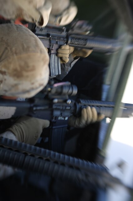 Marines with Heavy Equipment Platoon, 8th Engineer Support Battalion, 2nd Marine Logistics Group, engage enemy targets after receiving hostile fire while in the back of a 7-ton truck during a live-fire convoy operation in the Combat Center’s training area Saturday as part of exercise Sidewinder, a pre-deployment training exercise for the battalion’s upcoming deployment to Iraq.