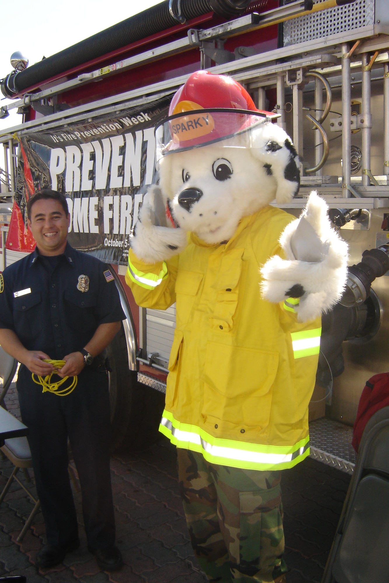 Sparky the Fire Dog stands with Capt. Ben Worley, March ARB Fire Department, in front of the BX, Oct. 9, to give out information about Fire Prevention Week. (U.S. Air Force photos by photos by Will Alexander)