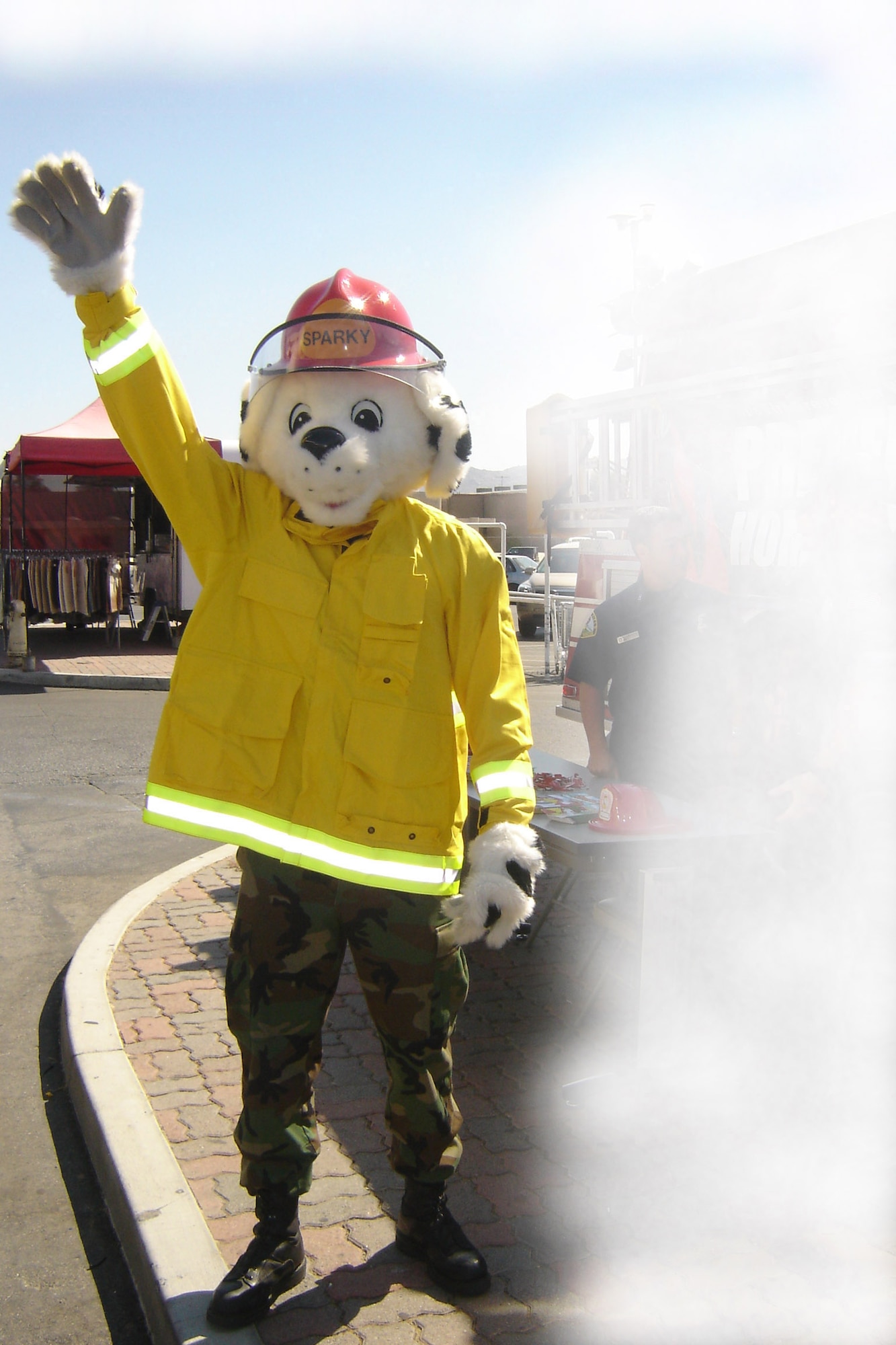 Sparky the Fire Dog (left) waves at drivers and BX patrons. (U.S. Air Force photos by photos by Will Alexander)