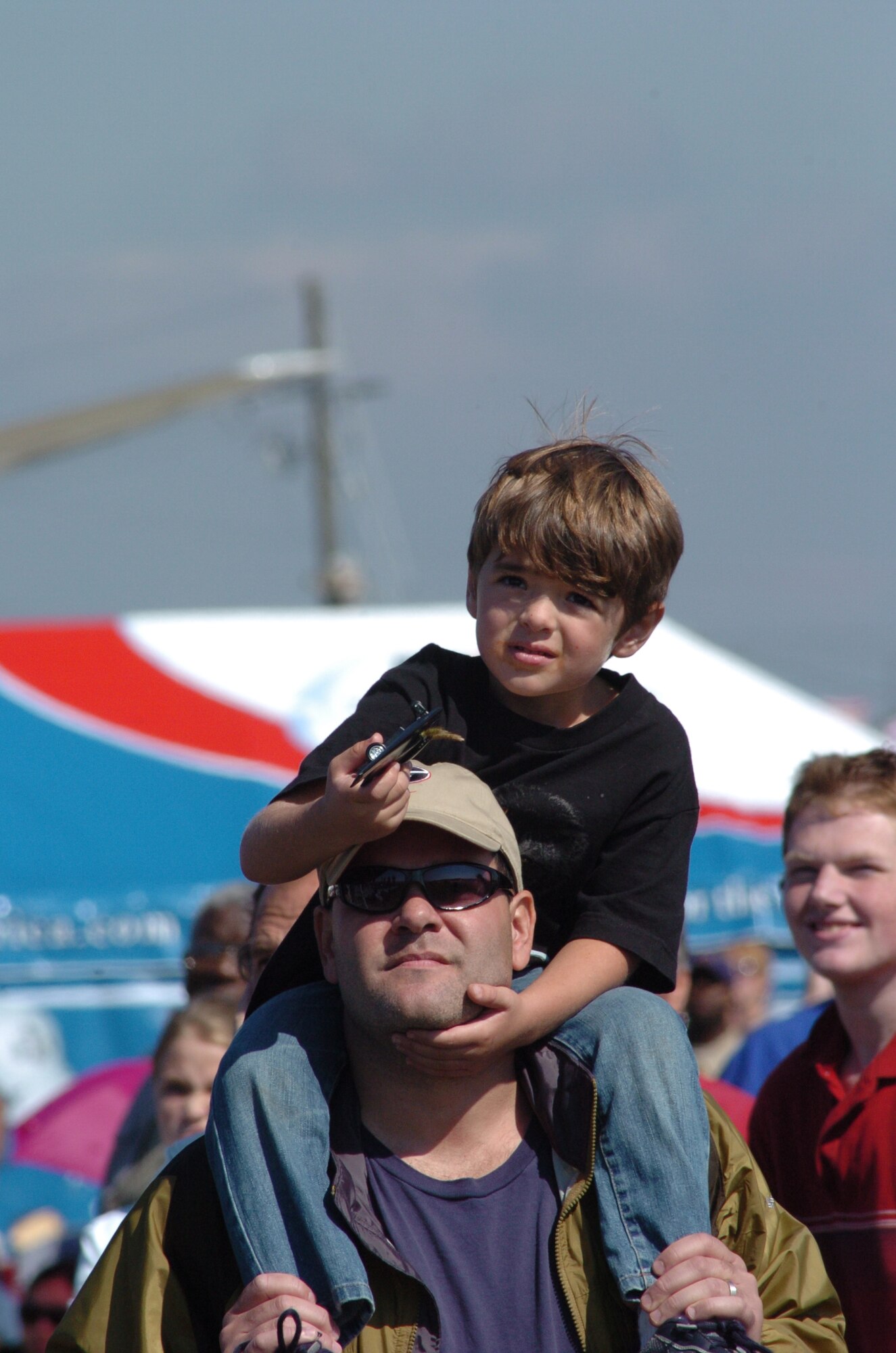 DOBBINS AIR RESERVE BASE, Ga. -- A young spectator gets a lift while watching the F-22 Raptor perform during the "Wings Over Marietta" air show here Oct. 18.  The air show features the world-renowned U.S. Air Force Thunderbirds who are the featured act each day. (U.S. Air Force photo/Master Sgt. Stan Coleman)