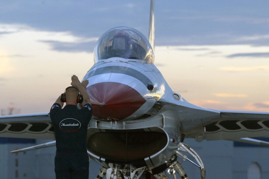DOBBINS AIR RESERVE BASE, Ga. -- An aircraft maintainer with the U.S. Air Force Thunderbirds give the signal for the F-16 jet to taxi to the runway.  The USAF Thunderbirds aerial demonstration are in town for the "Wings Over Marietta" air show here Oct. 18-19.  The Thunderbirds are the featured act each day. (U.S. Air Force photo/Don Peek)