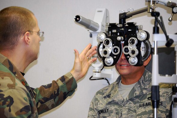 Maj. Joseph Rogalinsly, an optometrist with the 433rd Aerospace Medical Squadron, Just told Tech. Sgt. Stanley Bowley that his vision well within health standards. Sergeant Bowley recieved an optometry check during his annual physical. (U.S. Air Force Photo/Master Sgt. Collen McGee)