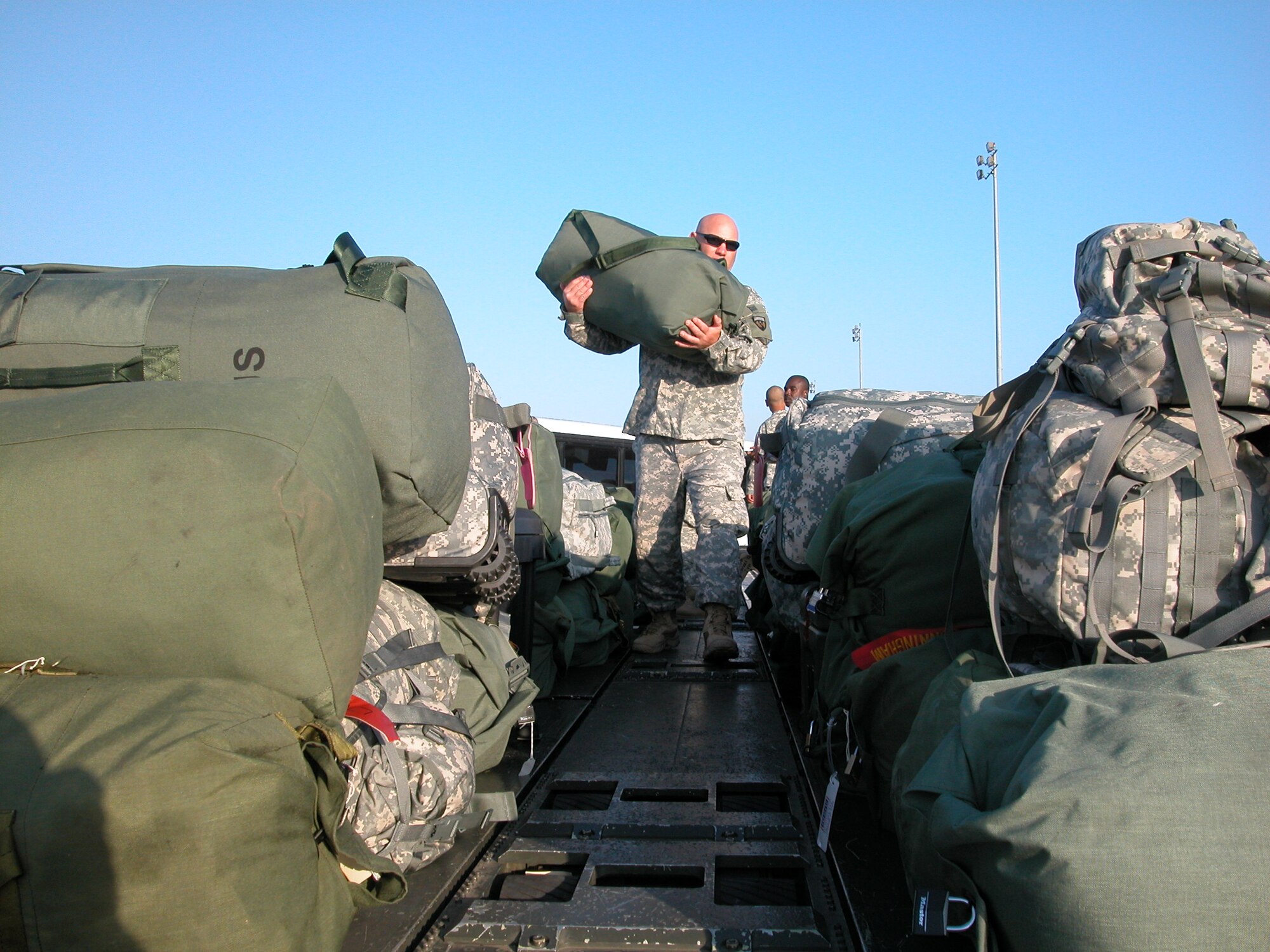 Master Sgt. Collin Carlson helps load one of the many duffle bags.Members of the Army National Guard’s 304th Sustainment Brigade load equipment on a K-loader to prepare for their unit’s deployment to Iraq. In all, they loaded about 36,500 pounds of cargo and personal equipment. After leaving March ARB, they flew to Fort Bliss, Texas where they will train for six weeks before heading to Iraq. According to 452 APSF, 34,000 people (approximately 22 million pounds) and about 56 million pounds of cargo are processed from March ARB each year. (U.S. Air Force photo by Staff. Sgt. Joe Davidson)