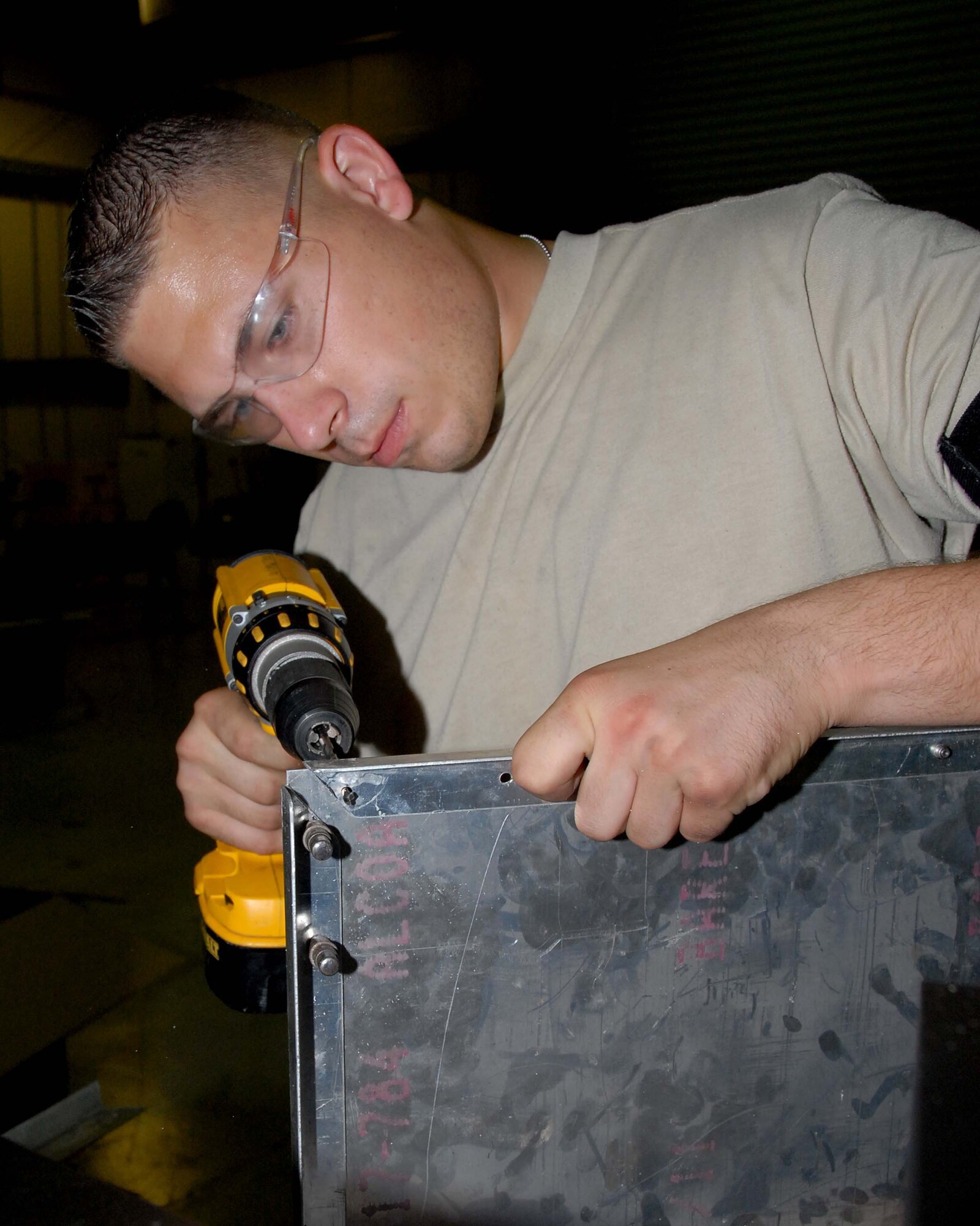 SOUTHWEST ASIA -- Senior Airman Jesse Spears drills holes to house rivets for shelving in the fabrication shop here Oct. 7. Airman Spears is an aircraft structural maintenance journeyman with the 380th Expeditionary Aircraft Maintenance Squadron. Airman Spears is deployed from Tinker Air Force Base, Okla. and calls Mascoutah, Ill., home. (U.S. Air Force photo by Tech. Sgt. Denise Johnson) (released)