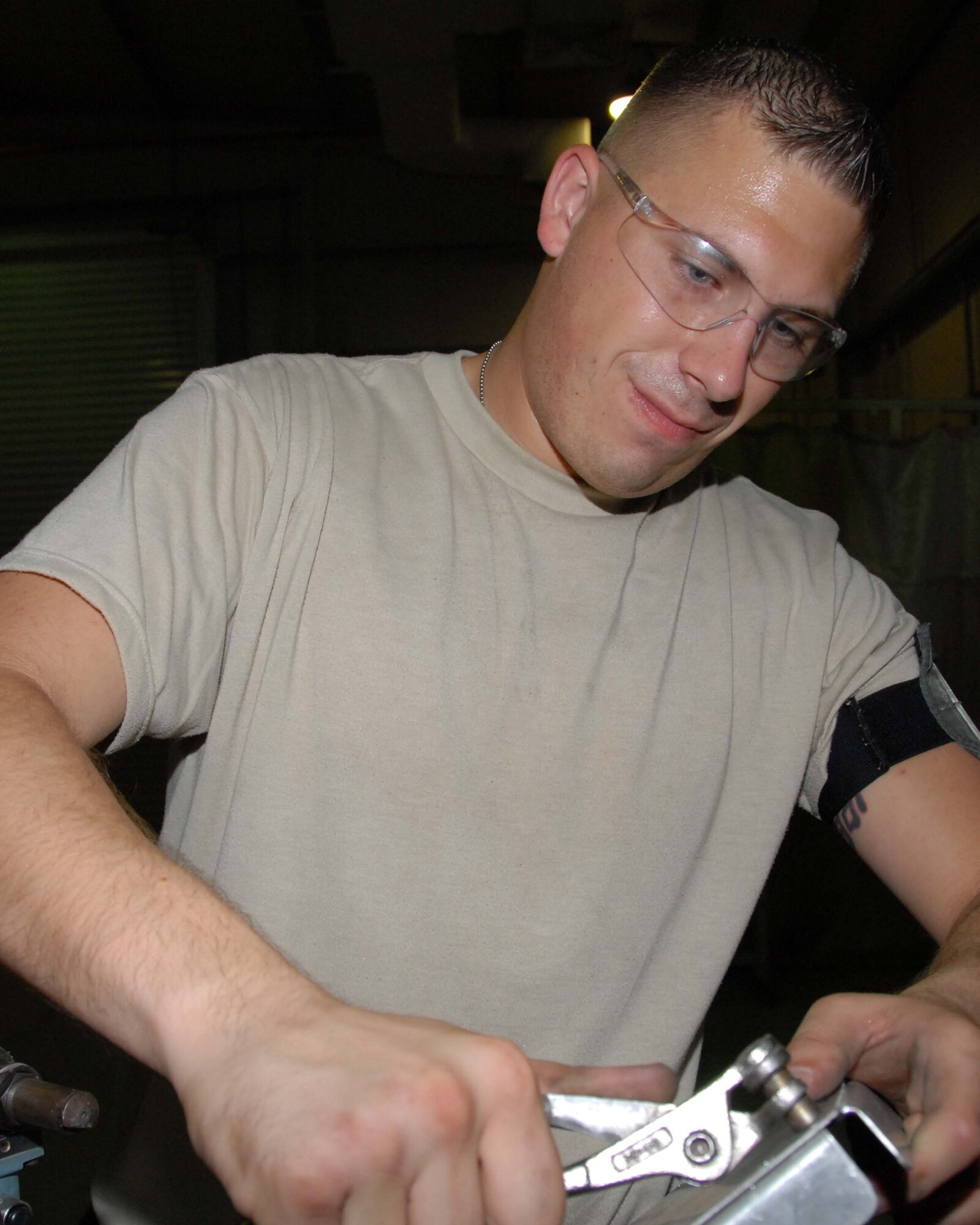 SOUTHWEST ASIA -- Senior Airman Jesse Spears attaches a rivet for shelving in the fabrication shop here Oct. 7. Rivets are attached with a rivet a gun and are used as a secure fastener to hold two pieces of metal together. Airman Spears is an aircraft structural maintenance journeyman with the 380th Expeditionary Aircraft Maintenance Squadron. Airman Spears is deployed from Tinker Air Force Base, Okla. and calls Mascoutah, Ill., home. (U.S. Air Force photo by Tech. Sgt. Denise Johnson) (released)