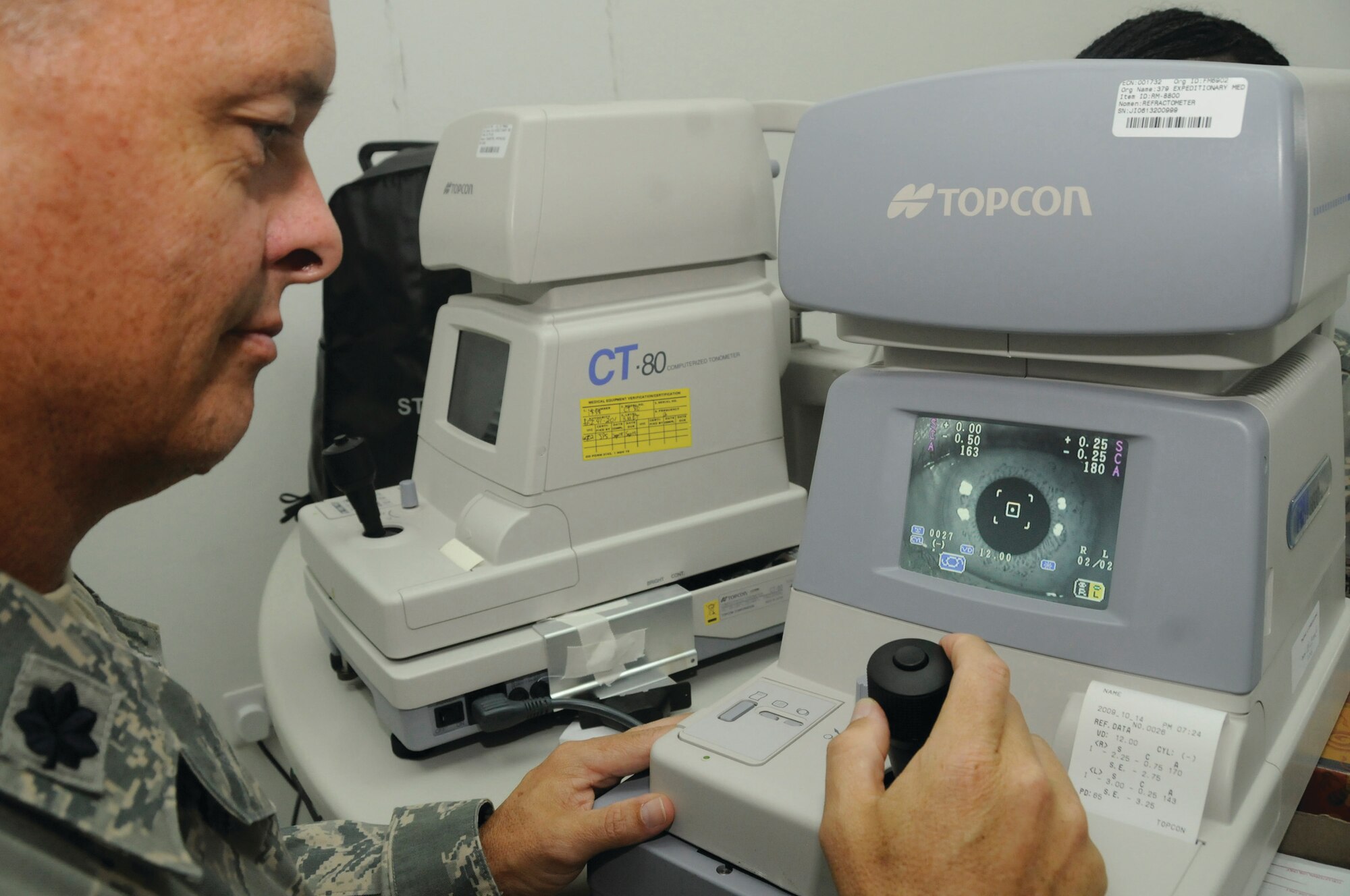 Lt. Col. Randall Collins, 379th Expeditionary Medical Group optometrist and Aeromedical/Dental flight commander, uses the tanometer to measure the eye pressure of Airman 1st Class Jakara Simmons, 379th Expeditionary Medical Group medical technician, here Tuesday. The optometry members are responsible for the vision readiness of more than 8,000 U.S. and Coalition servicemembers. Colonel Collins, a native of Lakeview, Ore., is deployed from Lackland Air Force Base, Texas, and Airman Simmons, a native of Charleston, S.C., is deployed from Maxwell AFB, Ala. 