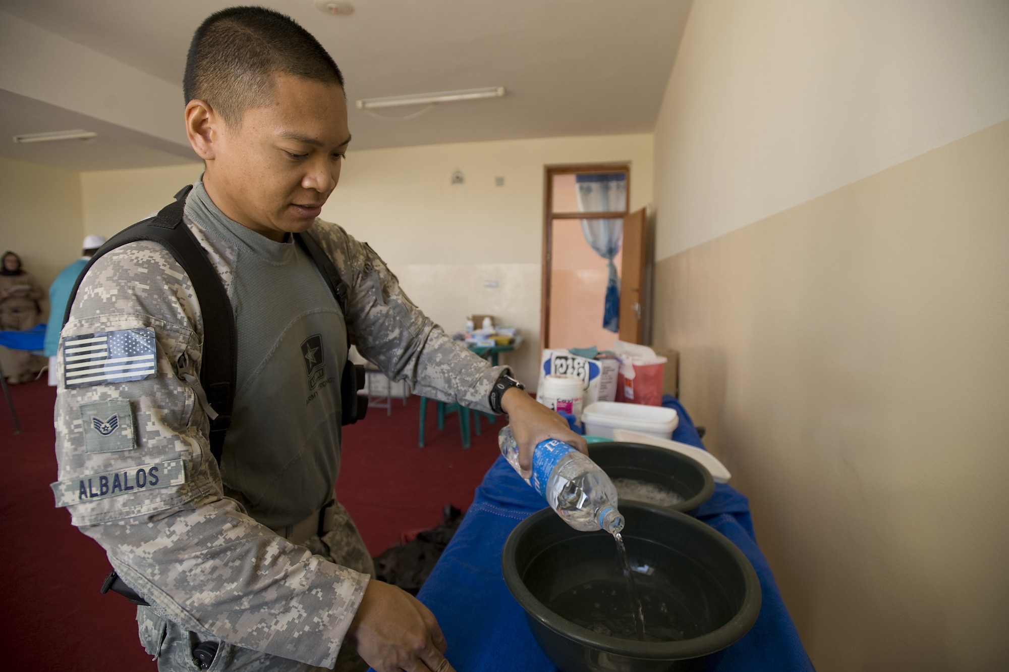 SHAJOY, Afghanistan -- Staff Sgt. Nestor Albalos prepares an infection control station to clean dental tools prior to a Village Dental Outreach visit here. The visit was hosted by the Zabul Provincial Reconstruction Team. Sergeant Albalos, PRT combat medic, assisted in the removal of teeth and sanitized tools during the visit. Sergeant Albalos, a native of Stockton, Calif., is deployed here from Travis Air Force Base, Calif. (U.S. Air Force photo/Master Sgt. Keith Brown)