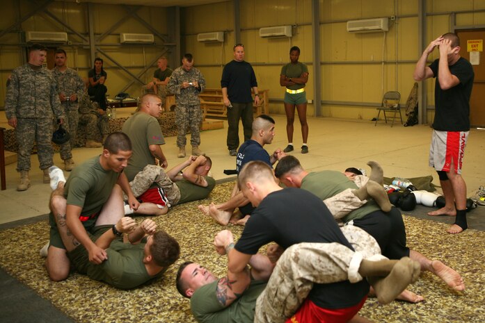 RAMADI, Iraq--Joe Lauzon, a professional fighter with the Ultimate Fighting Championship, demonstrates some grappling techniques at Camp Ramadi, Iraq, Oct. 19. Lauzon, Heath Herring and Jorge Rivera, all UFC fighters, held clinics at several forward operating bases throughout Iraq during an 11-day trip to the Middle East. The fighters taught servicemembers grappling techniques, stand-up fighting, and fighting in the clinch. After the clinic, the fighters signed autographs and posed for photos with everyone who came out to the event. (Official U.S. Marine Corps photo by Cpl. Stephen McGinnis) (Released)