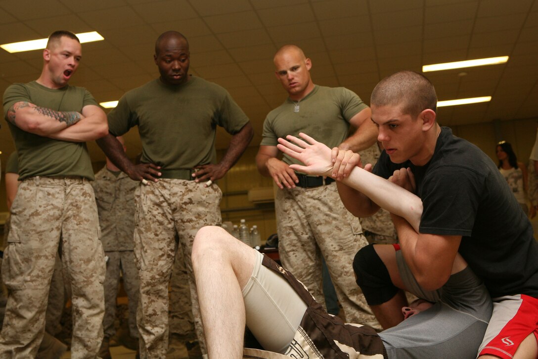 RAMADI, Iraq--Joe Lauzon, a professional fighter with the Ultimate Fighting Championship, demonstrates grappling techniques at Camp Ramadi, Iraq, Oct. 19. Lauzon, Heath Herring and Jorge Rivera, all UFC fighters, held clinics at several forward operating bases throughout Iraq during an 11-day trip to the Middle East. The fighters taught servicemembers grappling techniques, stand-up fighting, and fighting in the clinch. After the clinic, the fighters signed autographs and posed for photos with everyone who came out to the event. (Official U.S. Marine Corps photo by Cpl. Stephen McGinnis) (Released)