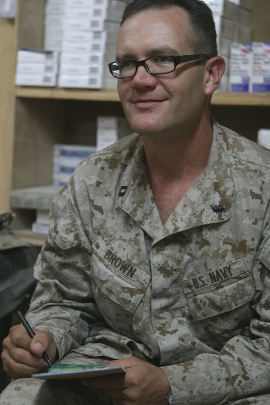 Navy Lt. Malcolm Brown, the battalion surgeon with Task Force 2nd Battalion, 2nd Marine Regiment, Regimental Combat Team 5, interviews a sailor about his Post Deployment Health Assessment answers at Rawah, Iraq, Oct. 19. "Everyone is required to do (a PDHA) to identify any illnesses or injuries that may have been caused while deployed," said Chief Petty Officer, Darryl Rice, senior medical department representative with the Battalion Aid Station, 2nd Bn., 2nd Marines.::r::::n::