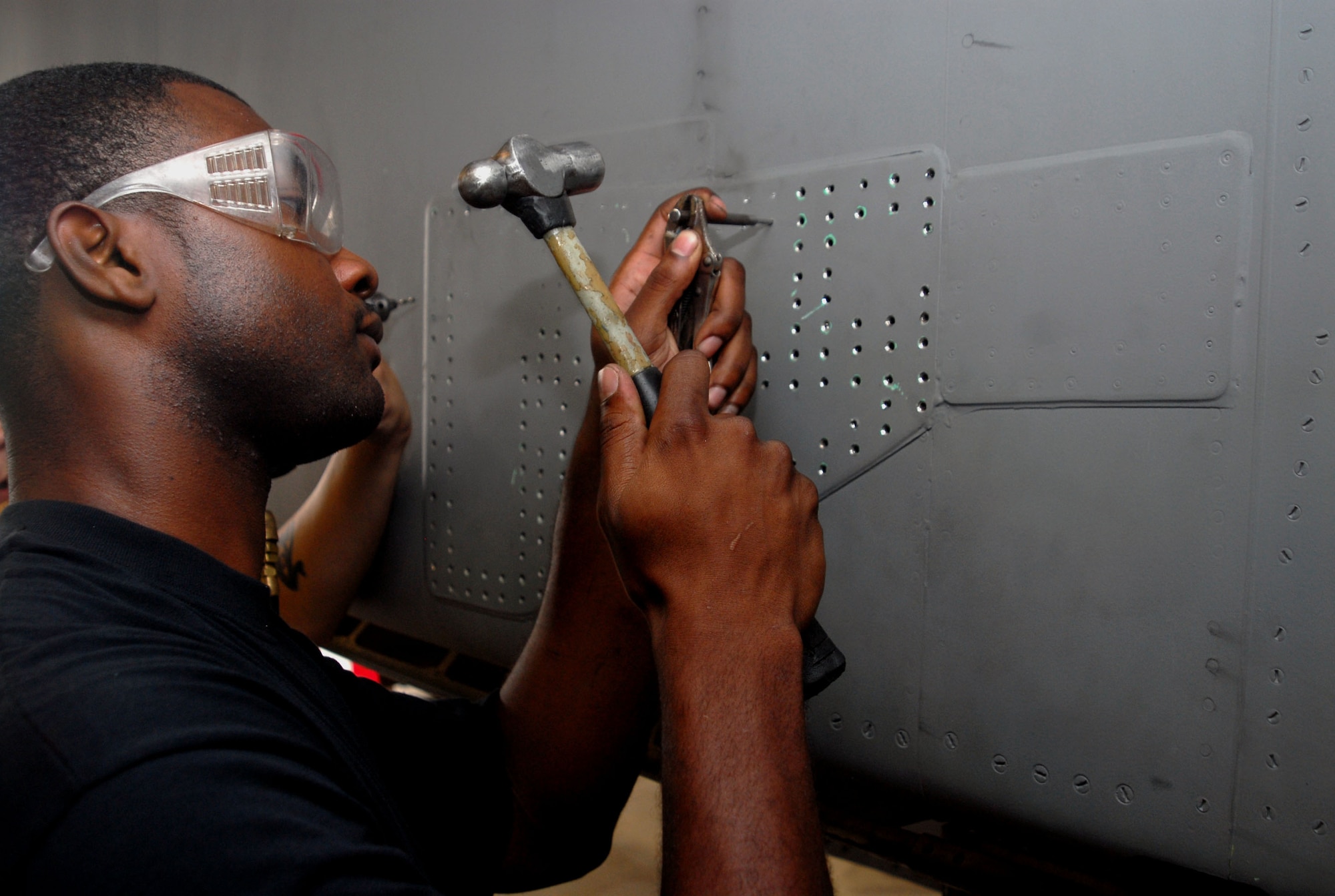 Senior Airman Victor Terrell, an 18th Equipment Maintenance Squadron structures flight technician, works on airframe repairs to an F-15 Eagle on Kadena’s flight line Oct. 16.  The structures flight works to ensure that all aspects of the F-15 frame is in top shape at all times.  (U.S. Air Force photo/Staff Sgt. Christopher Marasky)
