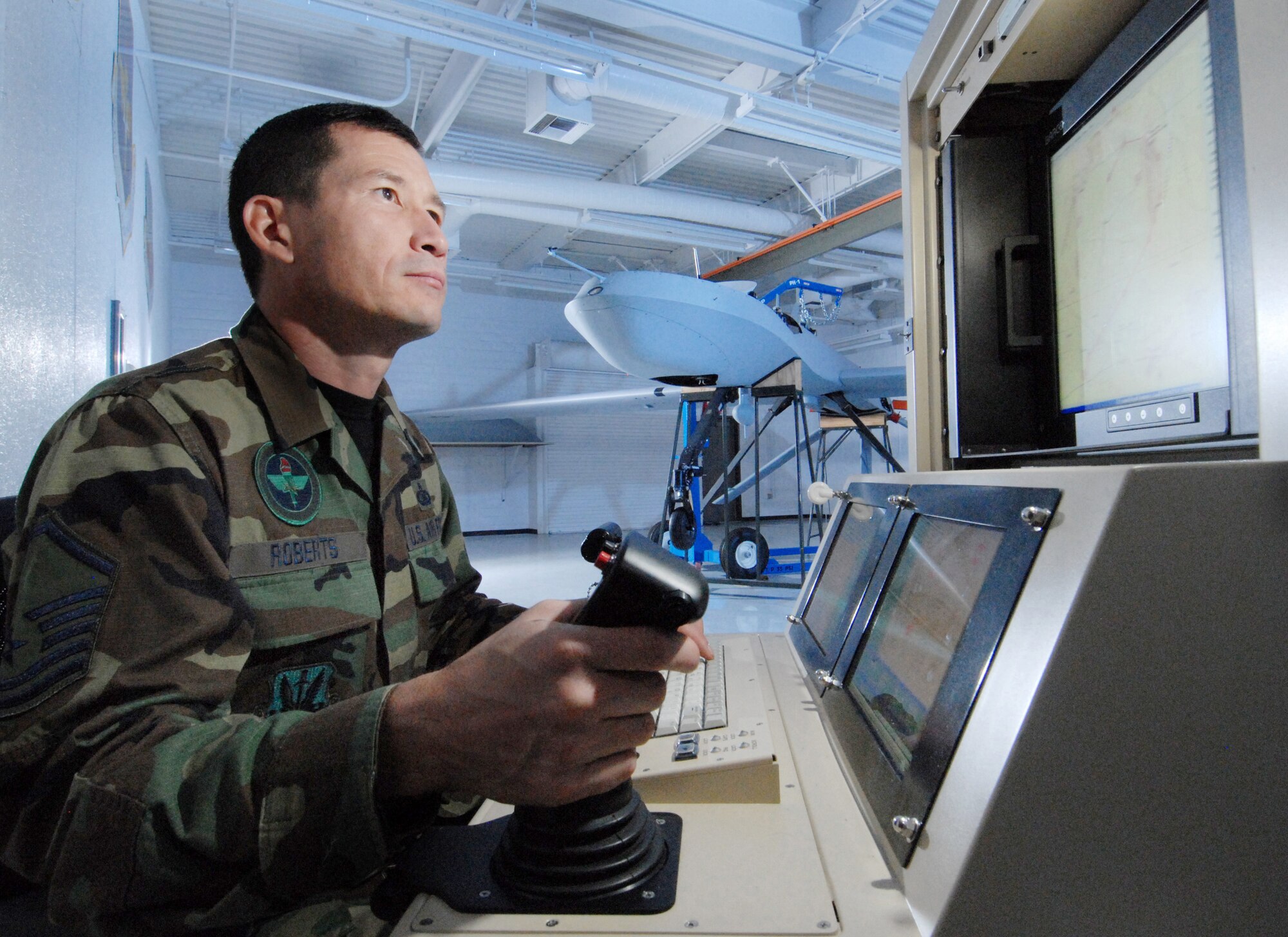 Master Sgt. Fred Roberts, an instructor assigned to FTD, 163 MXG, uses a Single Base Station maintenance interface station to check an MQ-1 Predator unmanned aerial vehicle. (U.S. Air Force photo by Val Gempis)