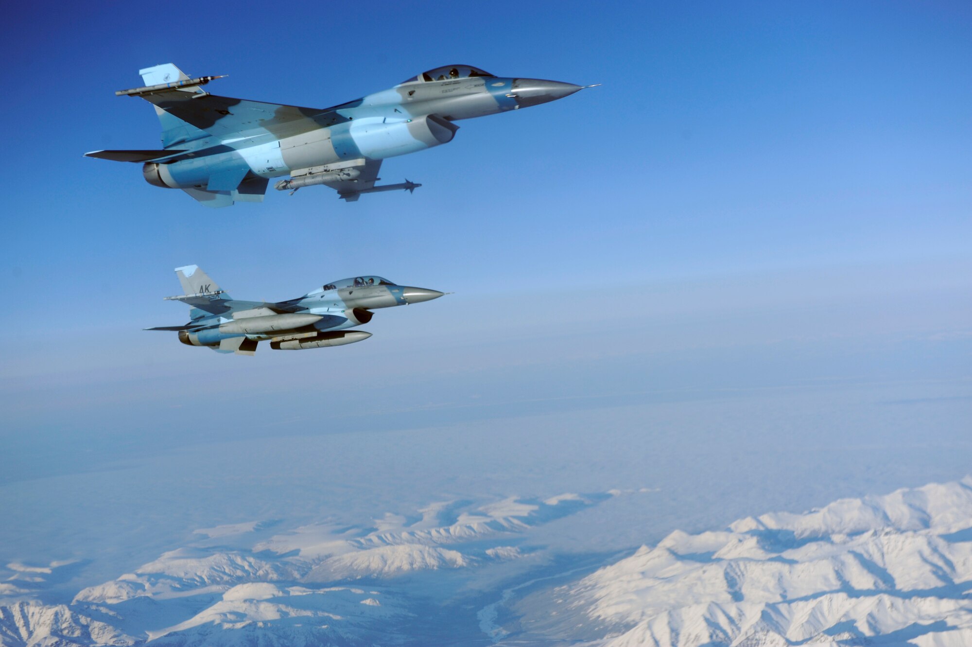 Two F-16 Aggressors fly in formation beside a KC-135 Stratotanker awaiting to be aerial refueled during RED FLAG-Alaska 09-1 Oct. 16, 2008, at Eielson Air Force Base, Alaska. During RF-A 18th Aggressor Squadron act as the opposing force employing enemy tactics while engaging in aerial combat over the Pacific Alaskan Range Complex. Both F-16 are assigned to the 18th Aggressor Squadron, Eielson AFB, Alaska. The KC-135 is assigned to the 384th Air Refueling Squadron, McConnell Air Force Base, Kan.  (U.S. Air Force photo/Senior Airman Jonathan Snyder)