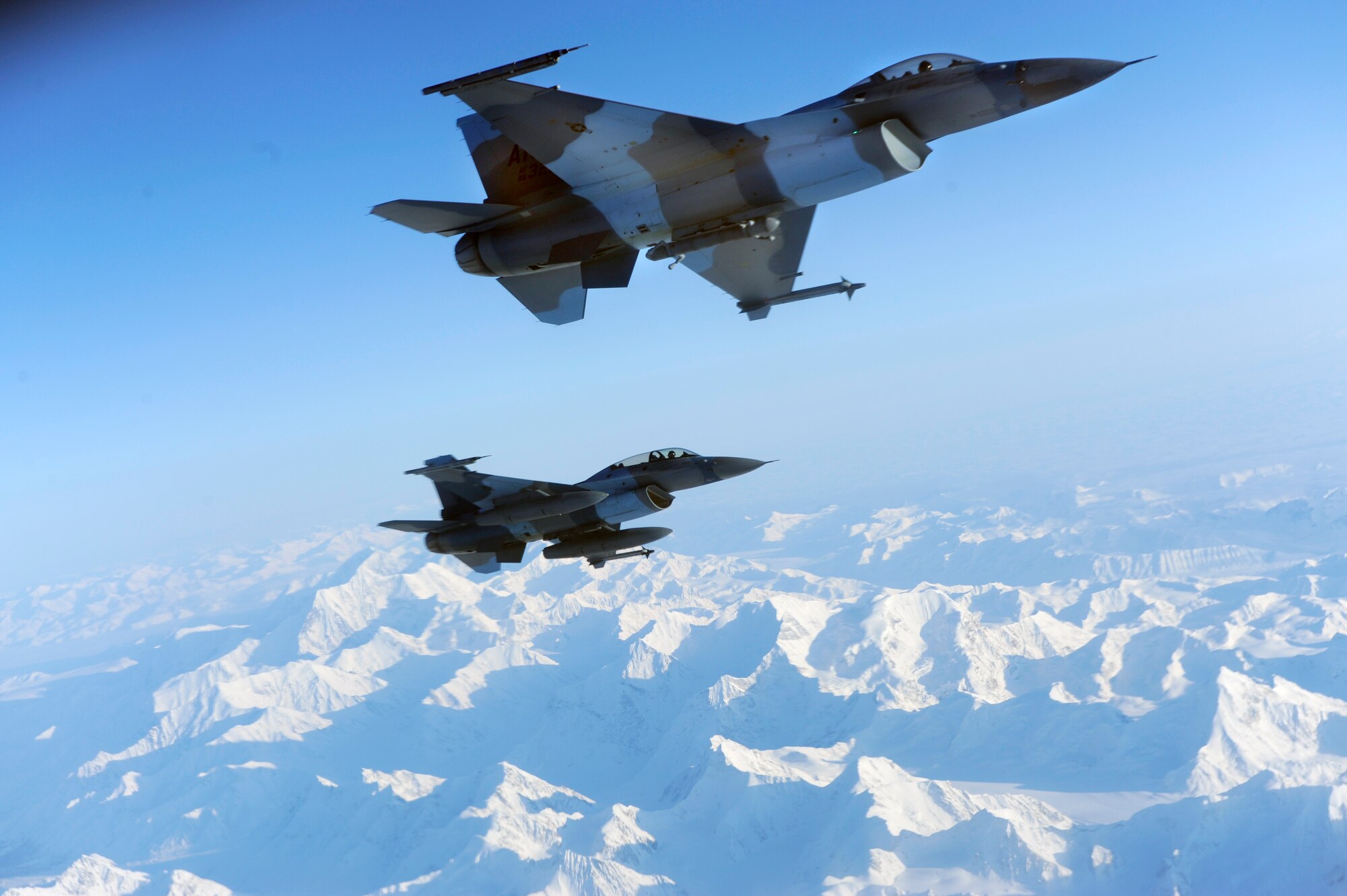 Two F-16 Aggressors fly in formation beside a KC-135 Stratotanker awaiting to be aerial refueled during RED FLAG-Alaska 09-1 Oct. 16, 2008, at Eielson Air Force Base, Alaska. During RF-A 18th Aggressor Squadron act as the opposing force employing enemy tactics while engaging in aerial combat over the Pacific Alaskan Range Complex. Both F-16 are assigned to the 18th Aggressor Squadron, Eielson AFB, Alaska. The KC-135 is assigned to the 384th Air Refueling Squadron, McConnell Air Force Base, Kan.  (U.S. Air Force photo/Senior Airman Jonathan Snyder)