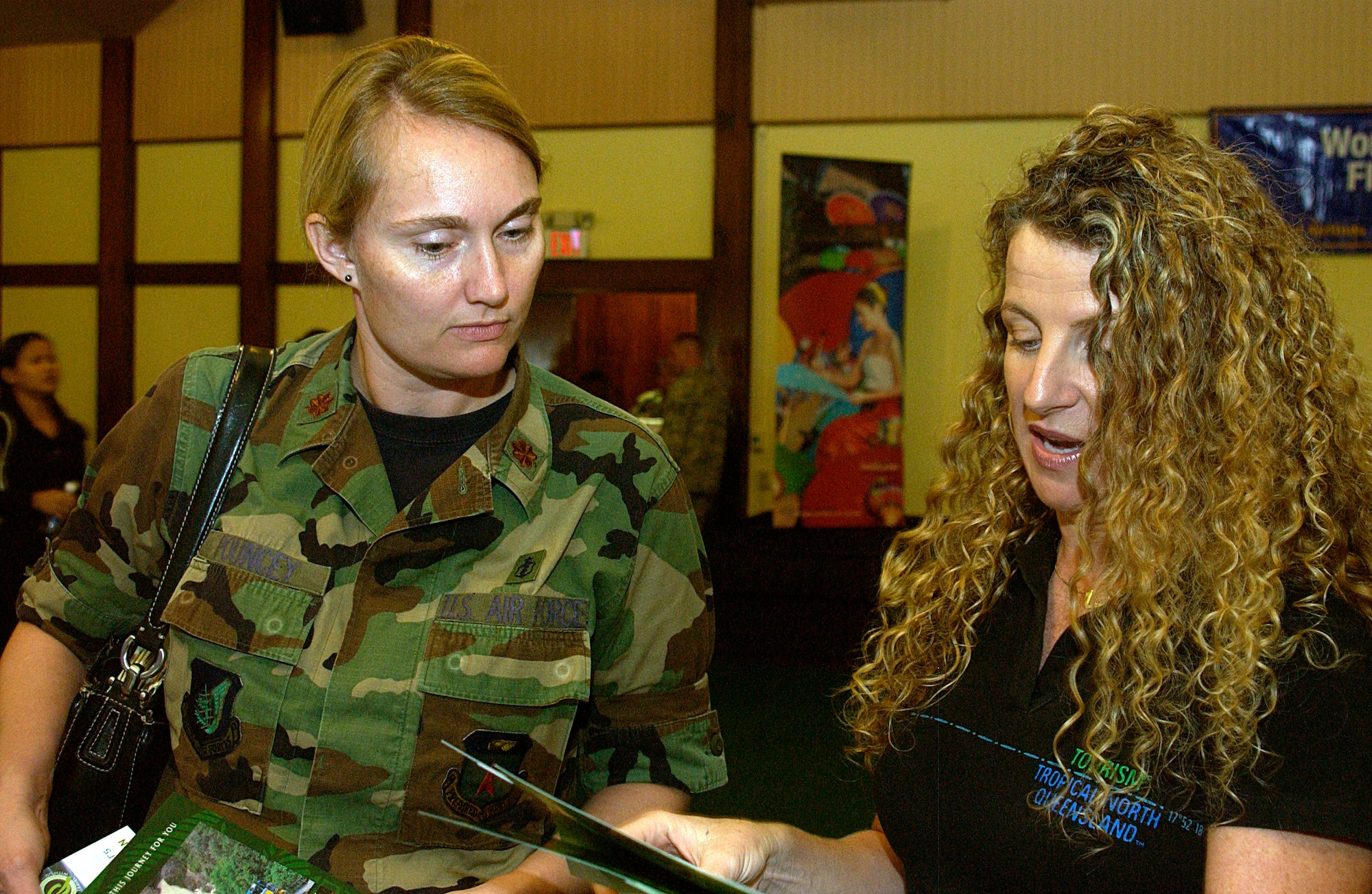 Maj. Cynthia Pouncey, 36th Medical Operations Squadron, learns about travel options from a tourism representative of the Tropical North Queensland booth at the Andersen Travel Fair held Oct. 16, at the Palm Tree Golf Course Conference Center, here. (U.S. Air Force photo by Airman 1st Class Carissa Wolff)                               