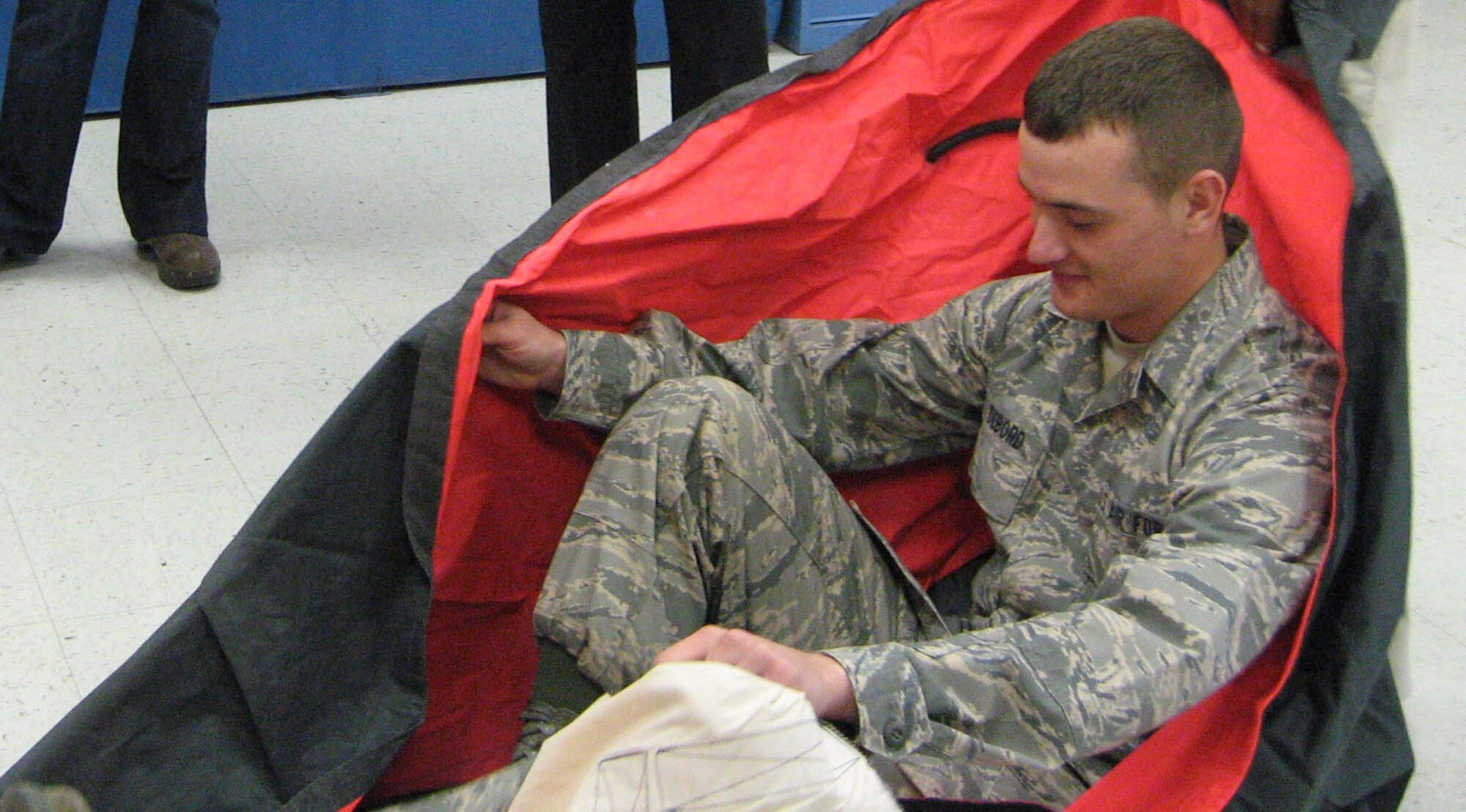 Airman Basic Billy DeBord, a student in the 361st Training Squadron, demonstrates how to inspect a one-man life raft for members of the Wichita Falls Junior League during a tour Oct. 16. The civic group explored the equipment sewing, survival raft, and parachute packing training programs at the 361st TRS along with a windshield and visit to the Heritage Center. (U.S. Air Force photo/Debi Smith)