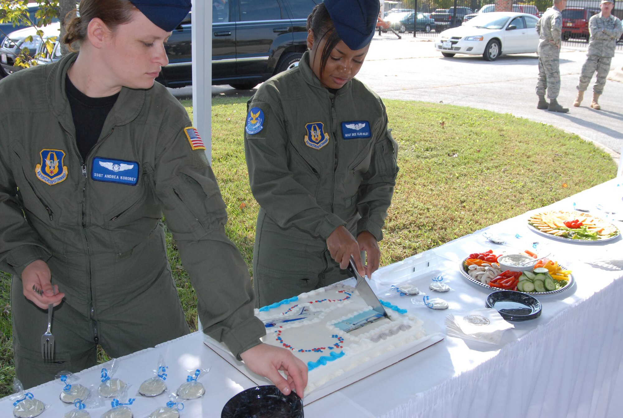 932nd Airlift Wing flight attendants cut the cake for the Illinois Air Force Reserve wing. The 932nd Airlift Wing celebrated with a cake showing the C-40C and C-9C during the initial ground breaking of the Air Force Reserve’s newest Operations Group facility and the combined 375th Airlift Wing / 932d Airlift Wing Command Post and Installation Control Center. U.S. Air Force photo/Tech. Sgt. Gerald Sonnenber