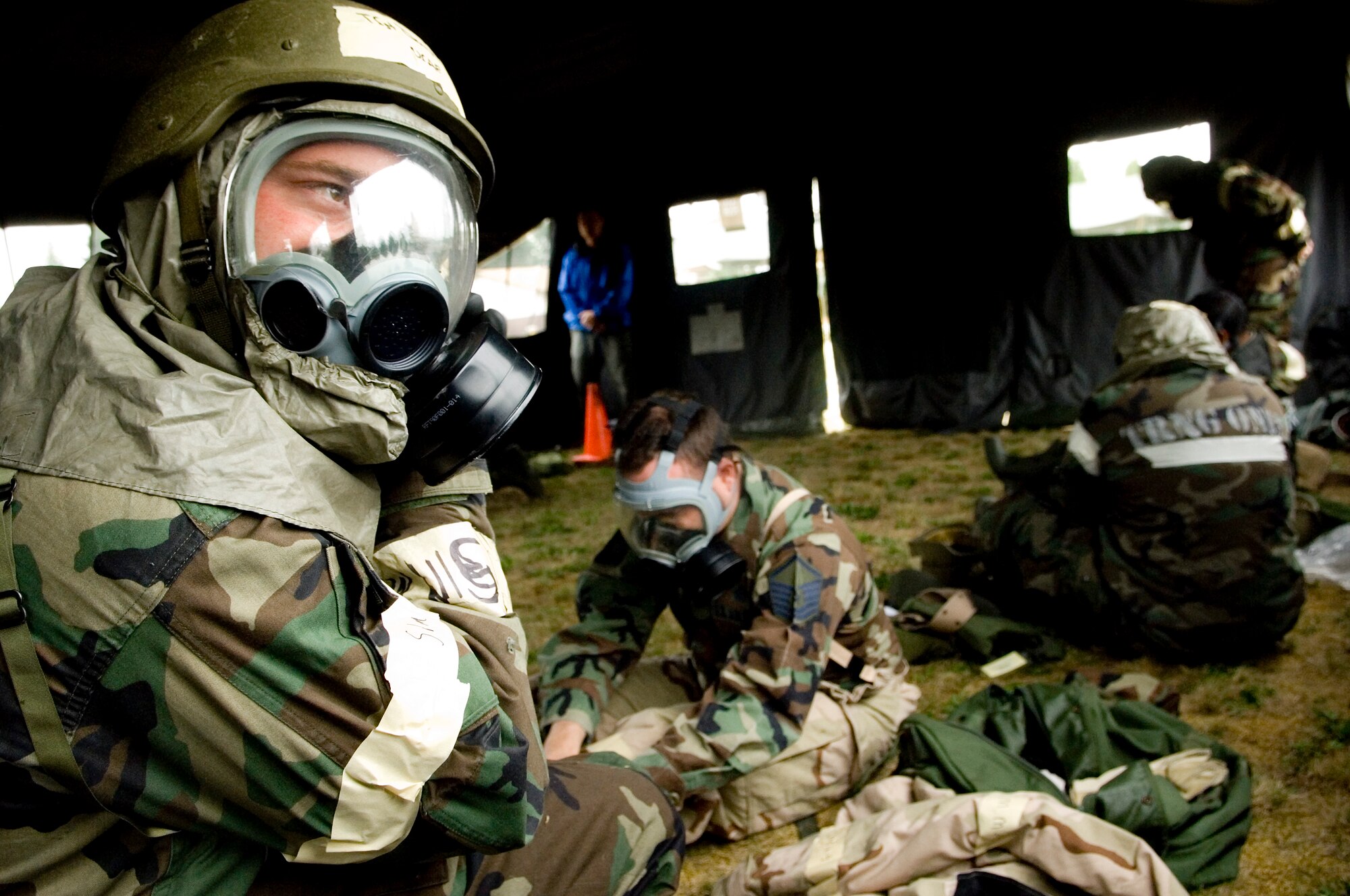 Airmen secure protective suits and masks during ability to survive and operate training Sept. 29 to Oct. 3 at McChord. The training was in preparation for the mobility exercise this week. The MOBEX tests the 62nd Airlift Wing’s ability to deploy, survive and operate in a combat environment and return home. According to the plans and programs staff, the MOBEX represents the first time that Team McChord has evaluated its war fighting capabilities since the last Operational Readiness Exercise in 2006. (U.S. Air Force photo/Abner Guzman)