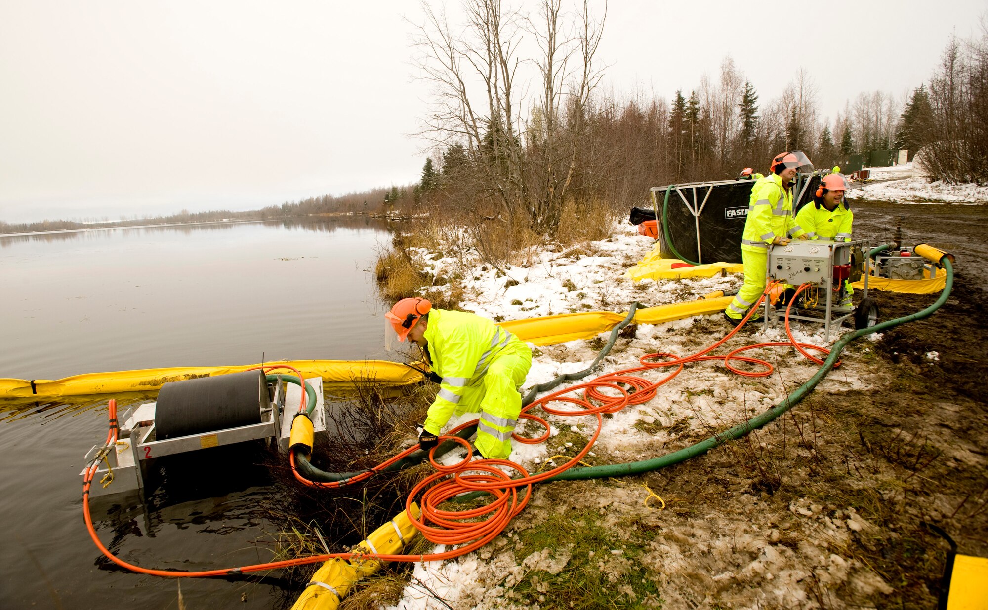 ELMENDORF AIR FORCE BASE, Alaska -- Tech. Sgt. Robert Lewallen, 611th Civil Engineer Squadron, pushes out the drum skimmer at Sixmile Lake Oct. 16. The drum skimmer is use to gather oil from a spill. (U.S. Air Force photo/Senior Airman Jonathan Steffen)