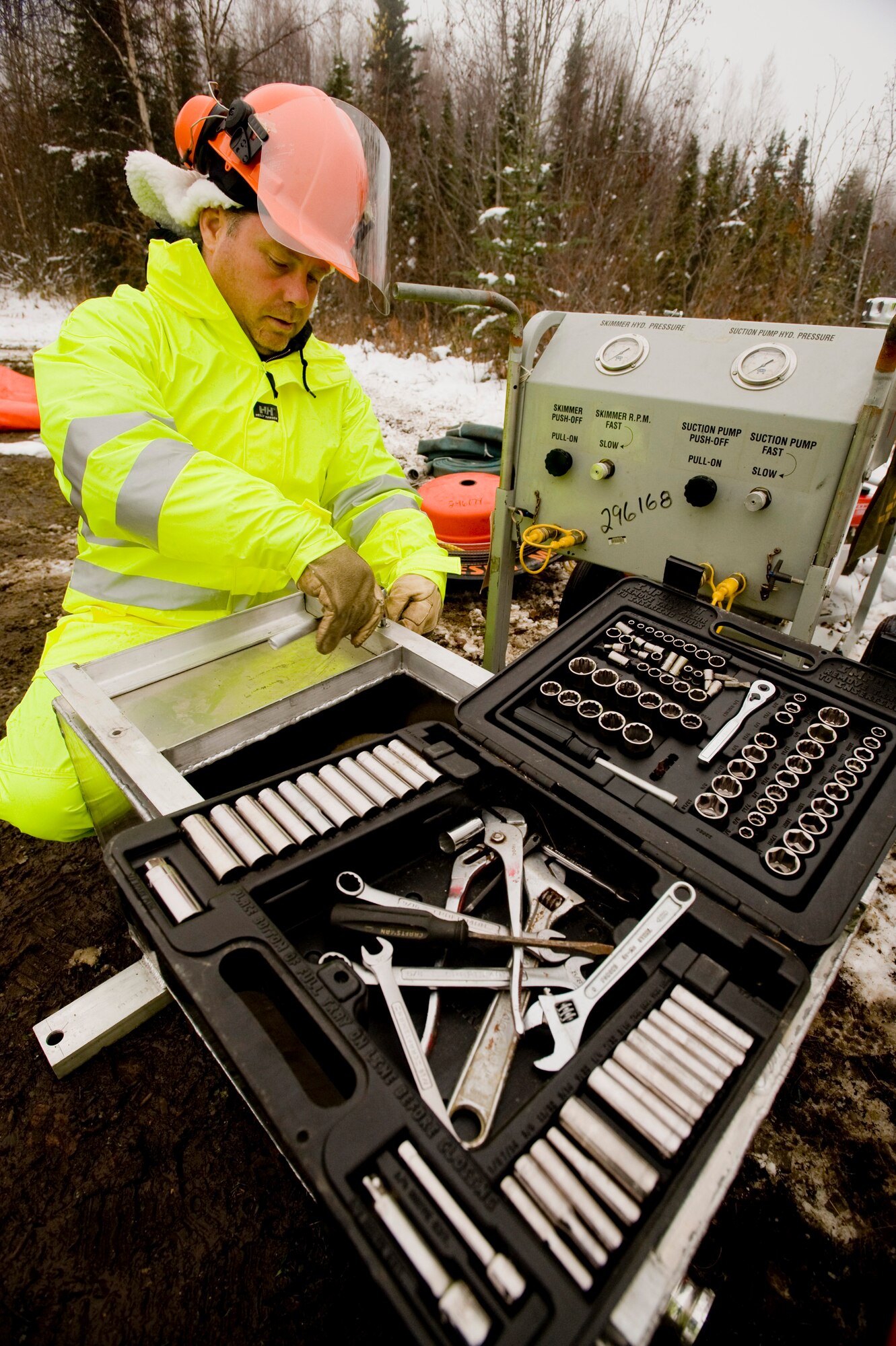 ELMENDORF AIR FORCE BASE, Alaska -- Steve Brunk, 611th Civil Engineer Squadron, assembles a rope skimmer at Sixmile Lake Oct. 16. The rope skimmer is use to gather oil from a spill. (U.S. Air Force photo/Senior Airman Jonathan Steffen)