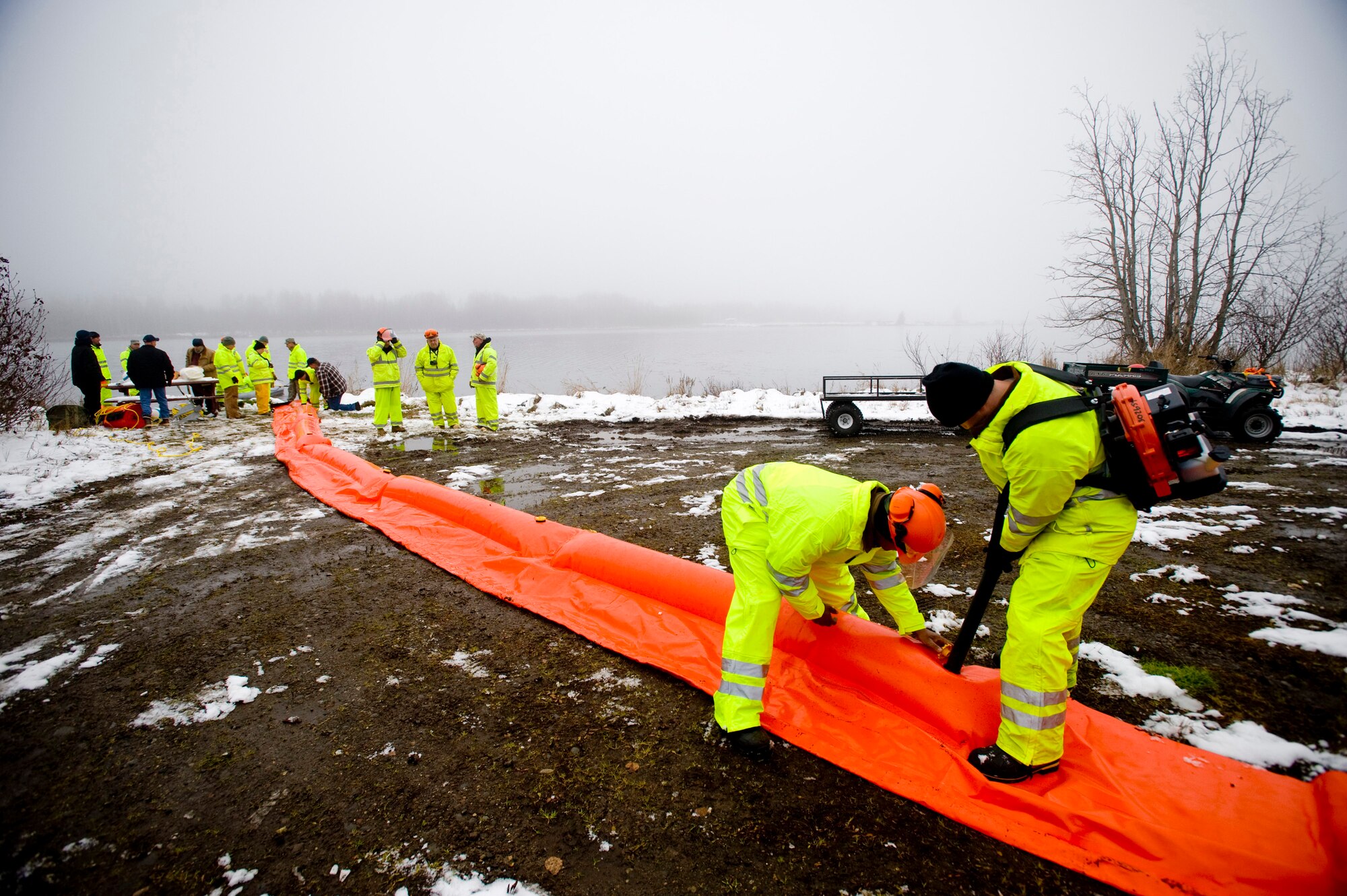 ELMENDORF AIR FORCE BASE, Alaska -- Master Sgt. William Cooper and Tech. Sgt. Eddie Campbell, 611th Civil Engineer Squadron, blows up the boom at Sixmile Lake Oct. 16. The boom is use to contain oil during an aquatic spill. (U.S. Air Force photo/Senior Airman Jonathan Steffen)