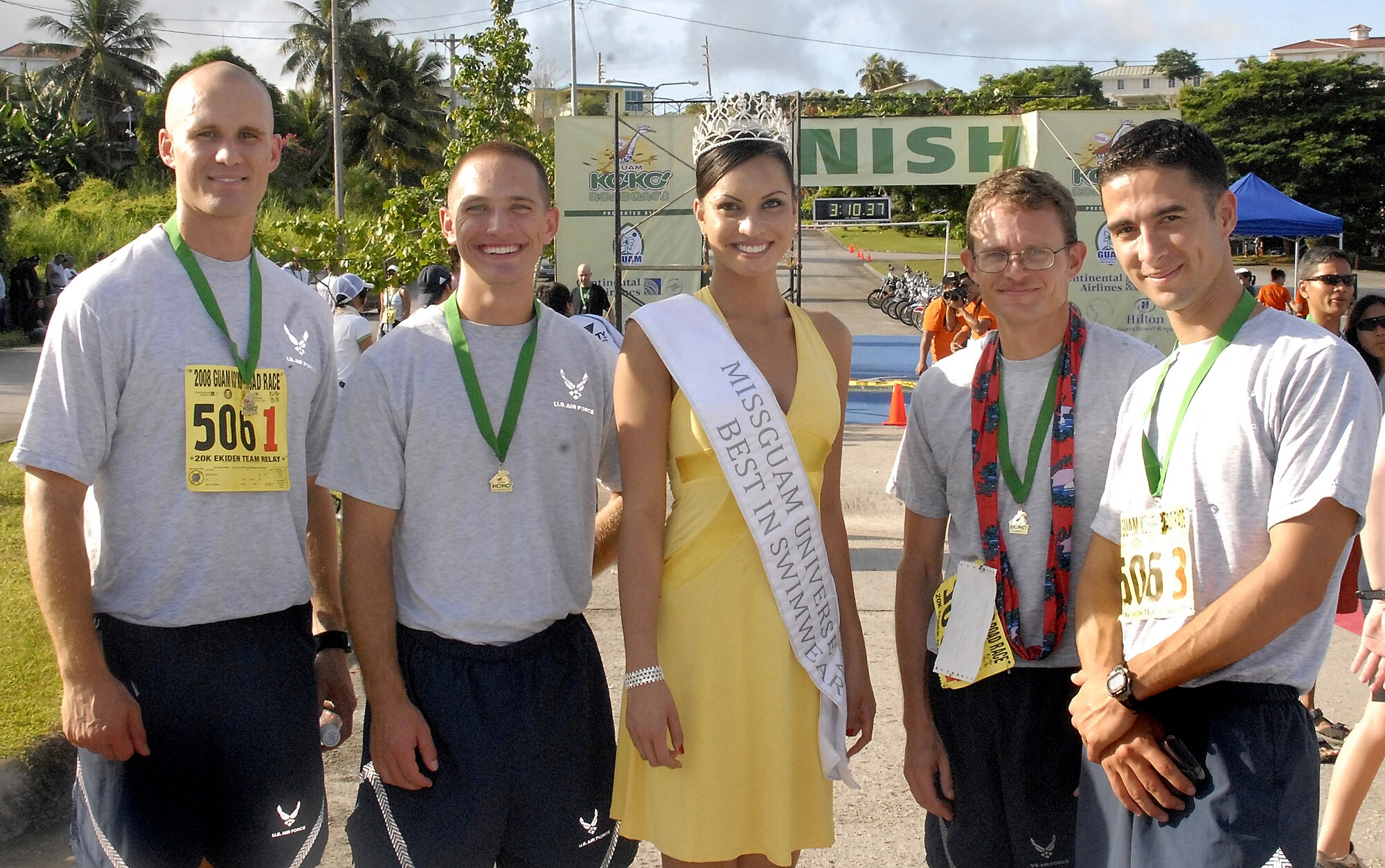 ANDERSEN AIR FORCE BASE, Guam-- Maria Luisa Santos, Miss Guam Universe 2008, poses for pictures with the "Air Force One" team (L to R) Capt. Brian Ellis, Airman 1st Class Travis Wilmoth, Tech. Sgt. Gerald Smith and 1st Lt. Tim Brown during the Guam Ko'ko' Road Race Oct.19. "Air Force One" came in 2nd place in the Military division of the 20 kilometer (12.42 mile) Ekiden relay. (U.S. Air Force photo by Master Sgt. Lisa M. Zunzanyika)