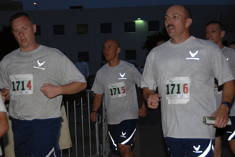 The 610th Intelligence Flight team rounds the corner for the finish in the Market to Market Relay Race Oct. 11. They ran from the Old Market in downtown Omaha to the Hay Market in downtown Lincoln for 86 miles. The race was the first of its kind consisting of 150 teams of six to eight people and covered 86 miles. (U.S. Air Force Photo Courtesy of 55th Wing Public Affairs)