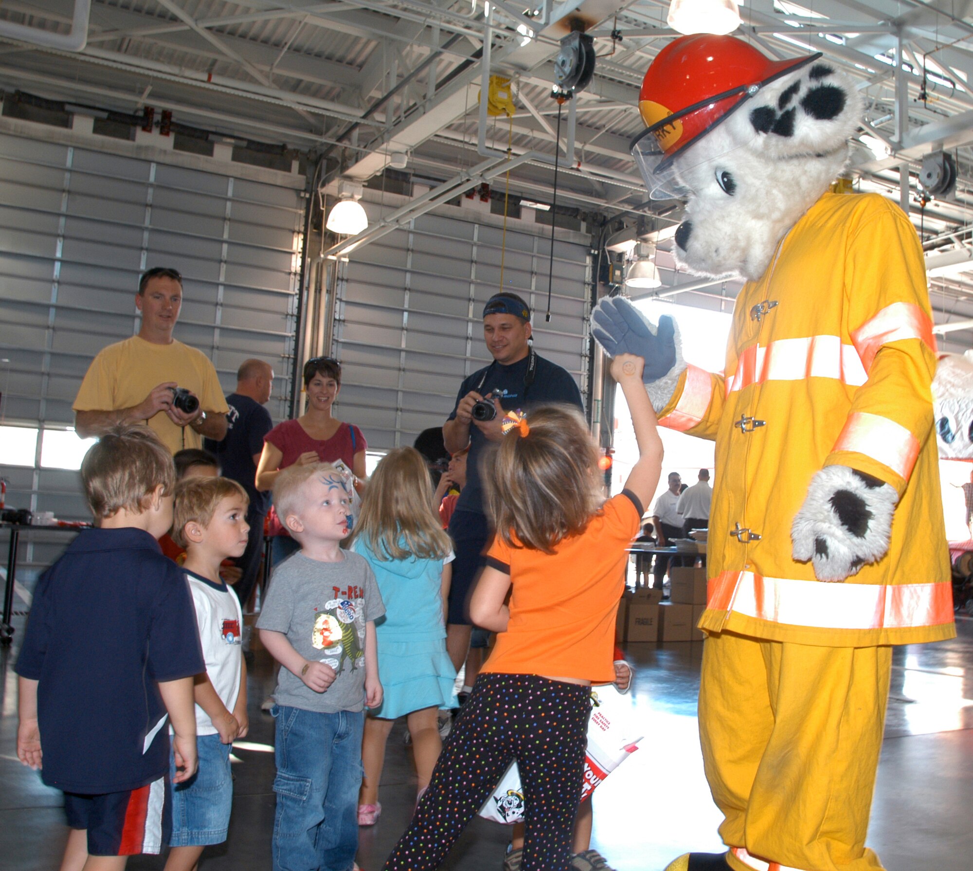 OFFUTT AIR FORCE BASE, Neb. -- Children received a visit from Sparky the fire dog during the 2008 Offutt Firestation Open House. Sparky would walk around and tell the children fire safety tips. Children also enjoyed a bounce house to jump on as well as various fire training drills for children offered by the Offutt firefighters. Oct. 11. (U.S. Air Force Photo By Jeff Gates)                                                                                                                                                              