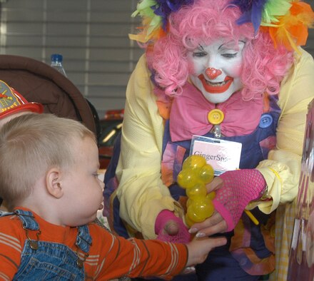 OFFUTT AIR FORCE BASE, Neb. -- Gingersnaps the Clown makes a balloon sculpture for Bo Diffendaffer, age two, son of Staff Sgt. Shawn Diffendaffer of the 610 Reserve Unit during the 2008 Offutt Fire Station Open House, Oct. 11 as part of this year’s National Fire Prevention Week activities. (U.S. Air Force Photo By Jeff Gates)                                                                                       
