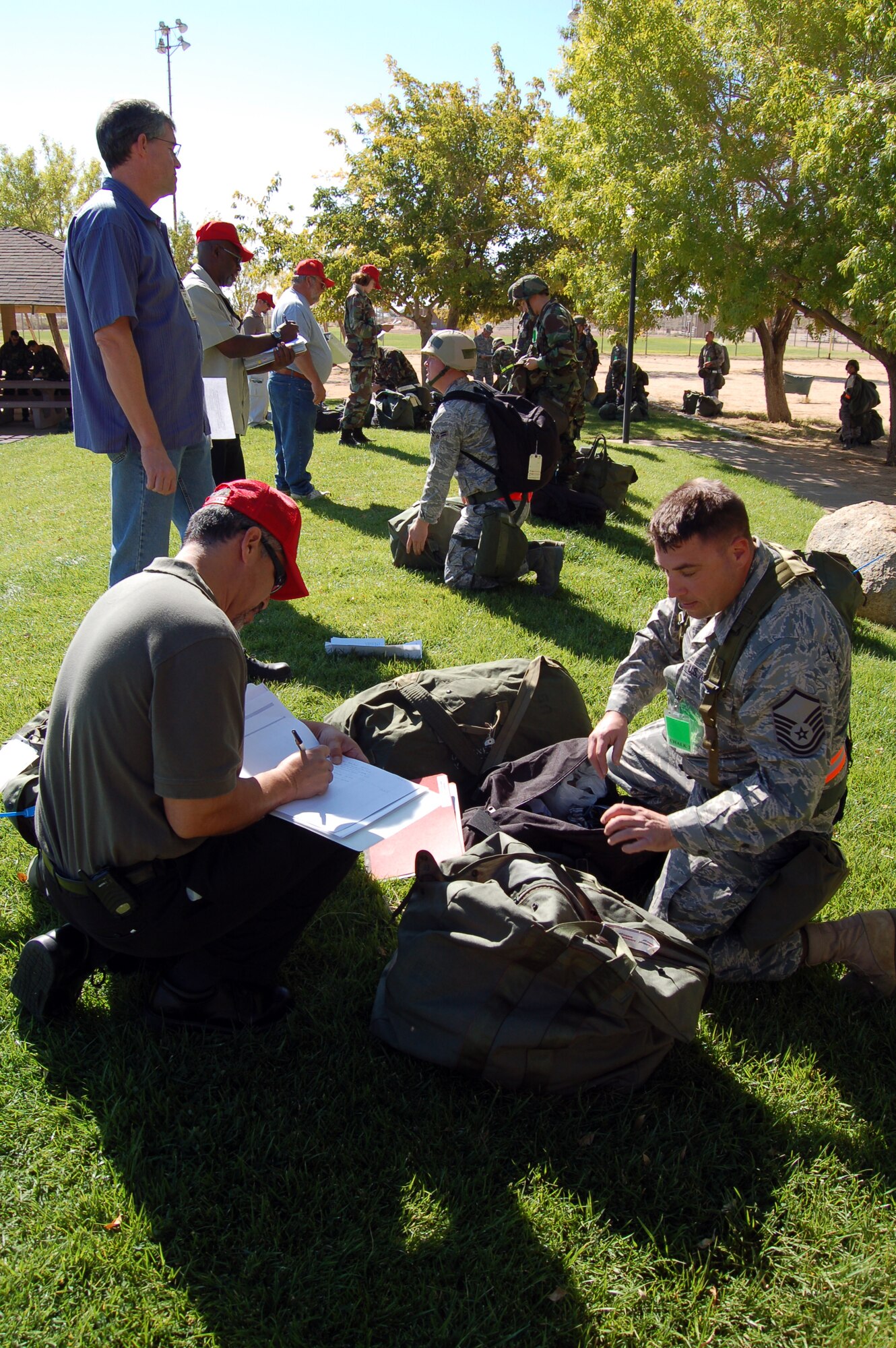 Exercise evaluation team members inspect deployed Airmen's mobility bags during a Phase II exercise at Arnold Park Oct. 20 in preparation for a Unit Compliance Inspection in January. The purpose of a UCI is to evaluate the Air Force's compliance with safety directives, federal law, executive order, Department of Defense and Air Force directives or instructions, and command policy directives and initiatives. (Air Force photo by Senior Airman Julius Delos Reyes)