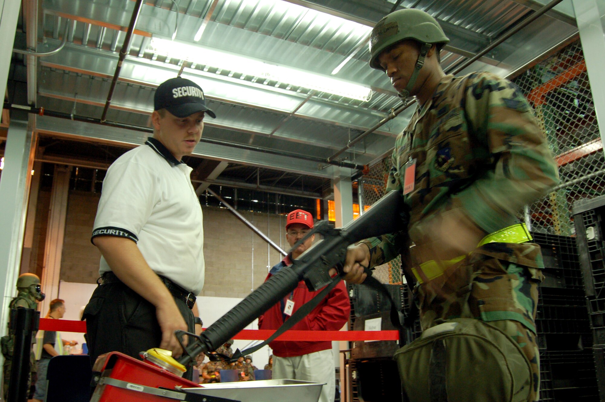 Senior Airman David Carter, 412th Test Wing information manager, inspects an M-16 rifle at the Edwards Mobility Processing Center Oct. 20. during a Phase I exercise in preparation for a Unit Compliance Inspection. The purpose of the UCI is to evaluate the Air Force Flight Test Center and Air Force Research Laboratory's compliance with safety directives, federal law, executive order, Department of Defense and Air Force directives or instructions, and command policy directives and initiatives. (Air Force photo by Senior Airman Julius Delos Reyes)