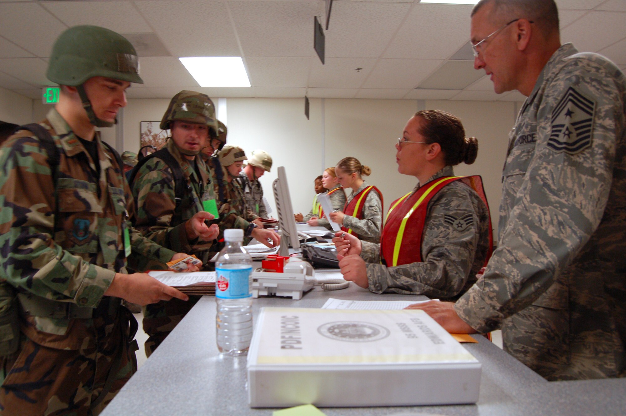 Airmen in-process for a deployment  at the Edwards Mobility Processing Center Oct. 20. during a Phase I and II exercise in preparation for a Unit Compliance Inspection in January. (Air Force photo by Senior Airman Julius Delos Reyes)