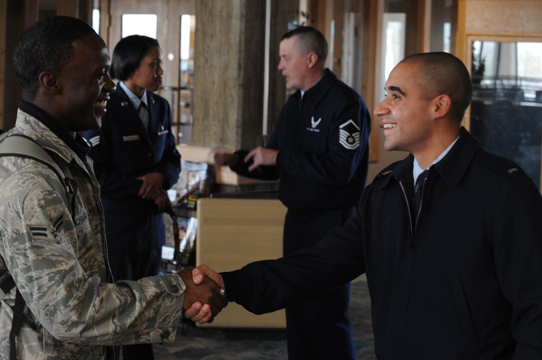 (Right) First Lieutenant Erik Ruiz, 28th Security Forces Squadron operations officer, greets Airman 1st Class Mason Richard, 28th Security Forces Squadron police officer, upon his return from a six-month deployment to Southwest Asia, at Rapid City Regional Airport in Rapid City, S.D., Oct. 20.  While serving in Southwest Asia, Airman 1st Class Mason Dixon provided rapid, decisive and sustainable mission support to Operations Iraqi Freedom and Enduring Freedom. (US Air Force Photo/ Airman 1st Class Adam Grant)
