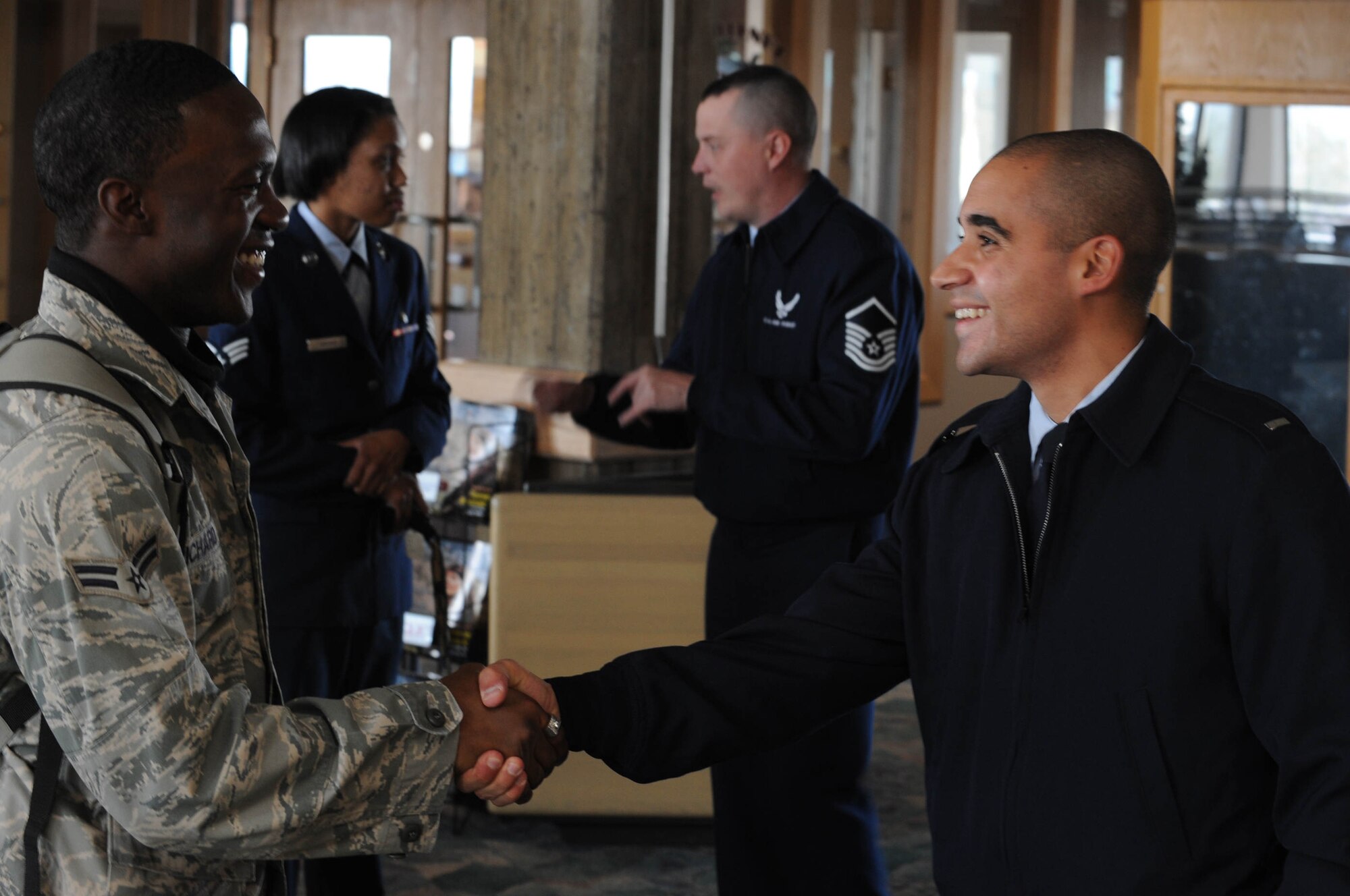 (Right) First Lieutenant Erik Ruiz, 28th Security Forces Squadron operations officer, greets Airman 1st Class Mason Richard, 28th Security Forces Squadron police officer, upon his return from a six-month deployment to Southwest Asia, at Rapid City Regional Airport in Rapid City, S.D., Oct. 20.  While serving in Southwest Asia, Airman 1st Class Mason Dixon provided rapid, decisive and sustainable mission support to Operations Iraqi Freedom and Enduring Freedom. (US Air Force Photo/ Airman 1st Class Adam Grant)