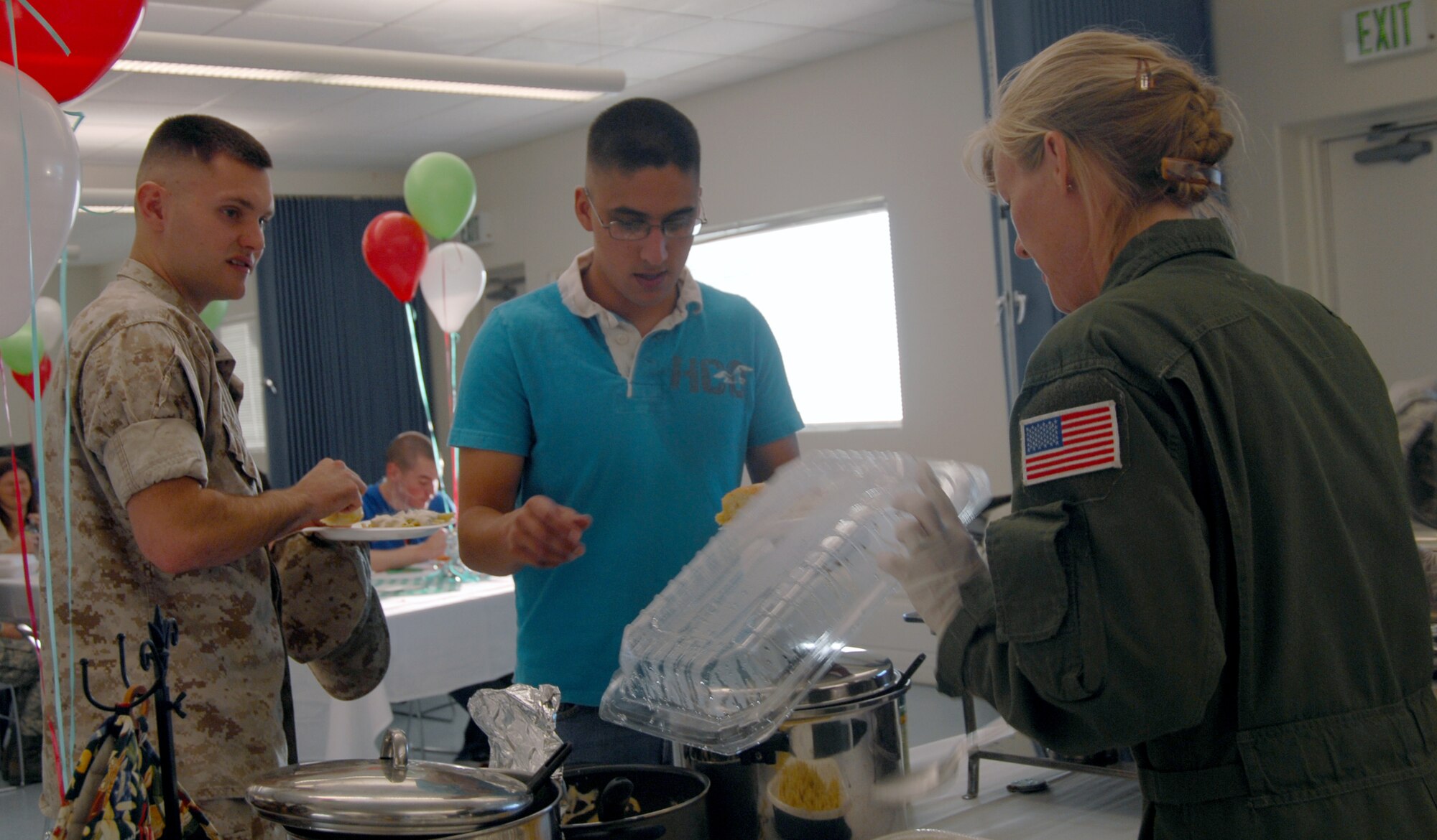 Master Sgt. Michelle Conner, 412th Flight Test Squadron executive flight attendant, serves food to dormitory residents during a dorm-dweller dinner at the Chapel 1 annex Oct. 14. The Edwards Top 3 sponsored the event. (Air Force photo by 2nd Lt. Belena Stuart)