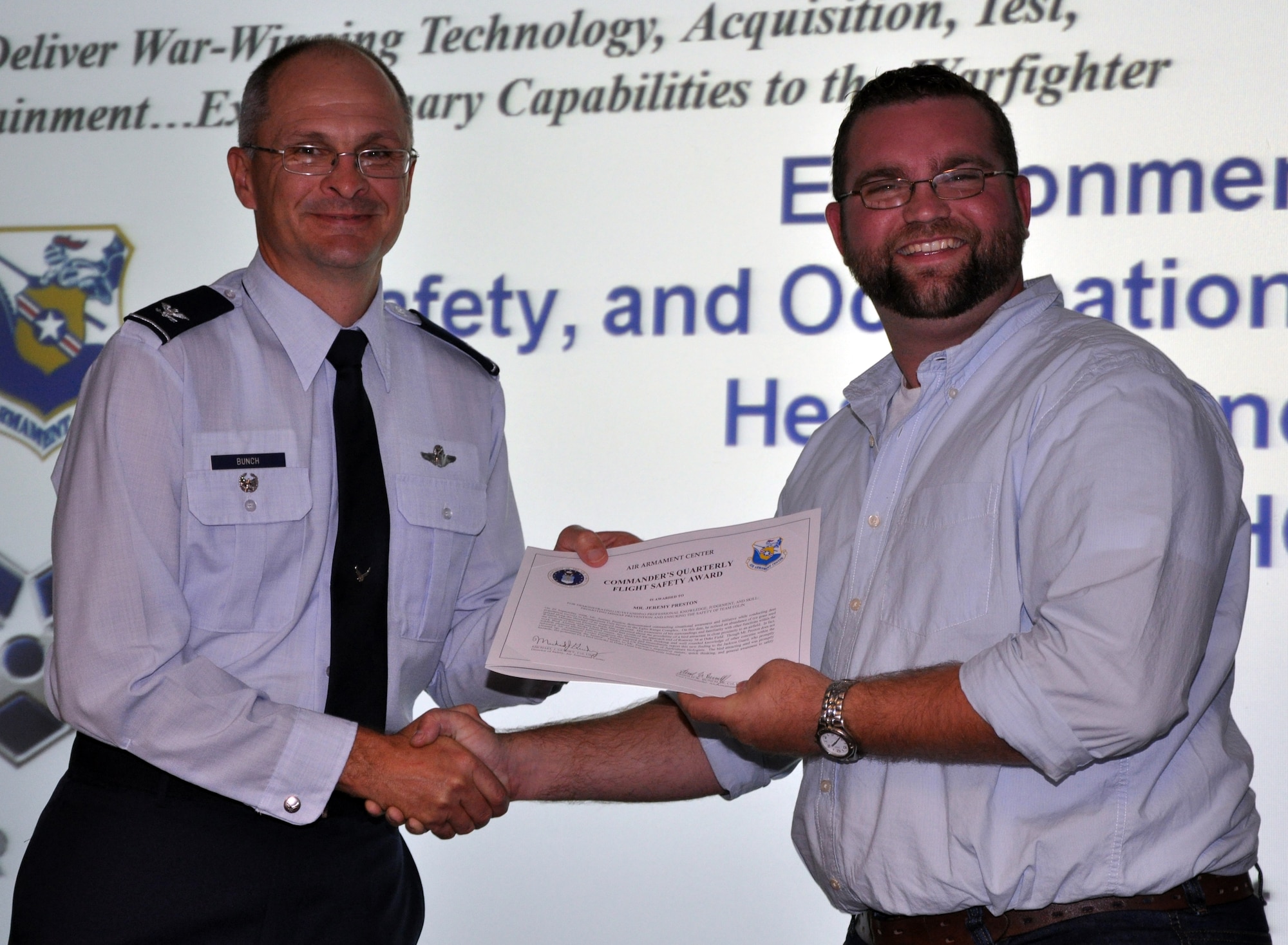 EGLIN AIR FORCE BASE, Fla. -- Col. Arnold Bunch, Air Armament Center vice commander,  presents Mr. Jeremy Preston, 96 Civil Engineer Group, with the Commanders Quarterly Flight Safety Award for his outsanding professional judgement, knowledge and skill prompting mishap prevention and ensuring the safety of Team Eglin. (US Air Force photo/ Airman 1st Class Anthony Jennings