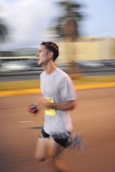 ANDERSEN AIR FORCE BASE, Guam- 1st. Lt.Tim Brown of the 23rd Expeditionary Bomb Squadron runs his leg of the Ekiden-relay during the Guam Ko'ko Road Race Oct. 19. Lieutenant Brown was one of the members of the "Air Force One" four-person relay team that took 1st place in the military division.  (U.S. Air Force photo by Master Sgt. Lisa M. Zunzanyika)

