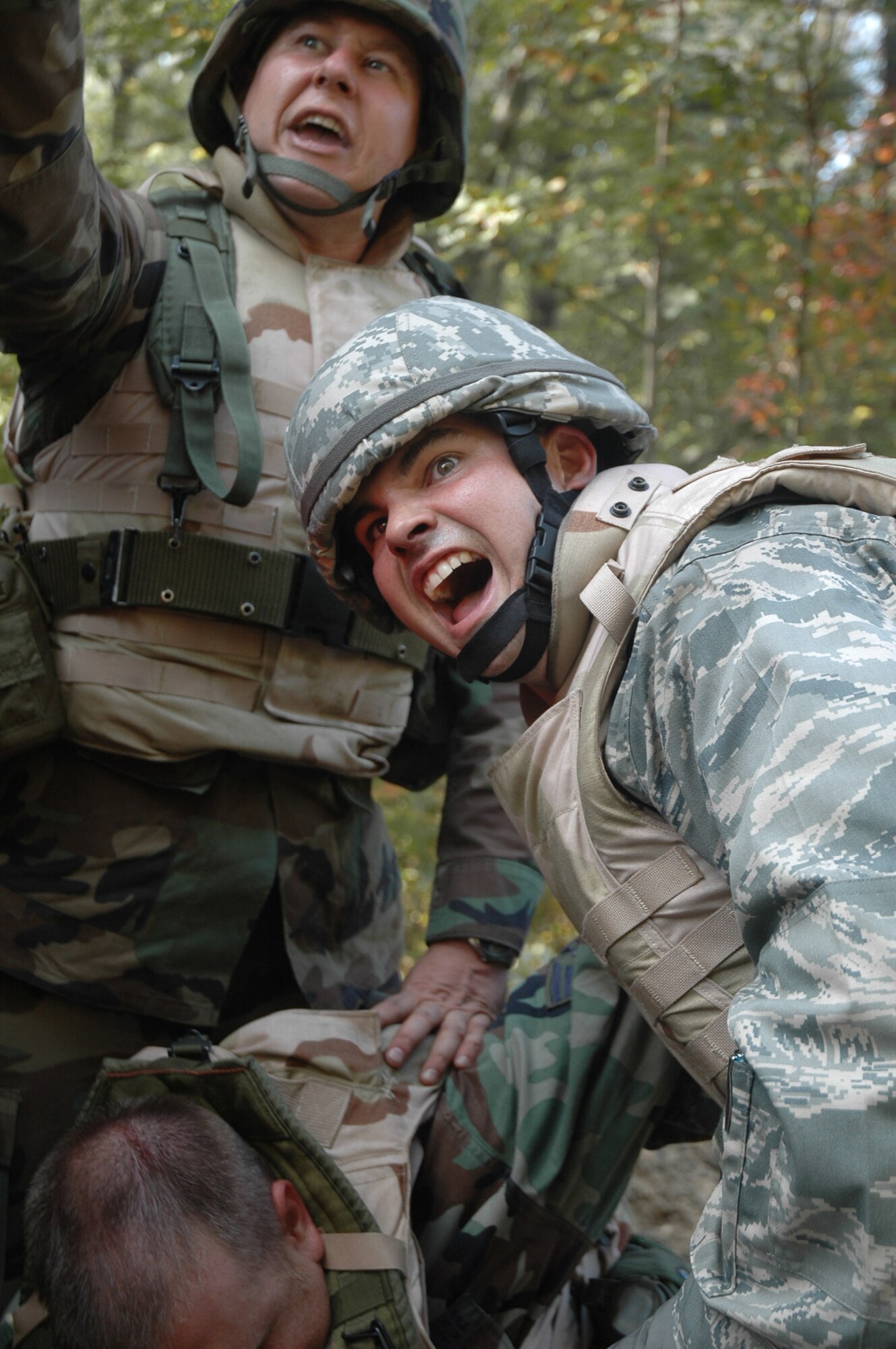 Tech. Sgt. Travis Oellerich from Scott Air Force Base, Ill., and Maj. Michael Davide from Peterson AFB, Colo., call for help to load an injured Airman into their HMMWV during training in convoy operations for the Advanced Contingency Skills Training Course 09-1 Oct. 9, 2008, on a Fort Dix, N.J., range.  ACST, taught by the U.S. Air Force Expeditionary Center's 421st Combat Training Squadron, prepares Airmen for upcoming deployments.  (U.S. Air Force Photo/Staff Sgt. Paul R. Evans)