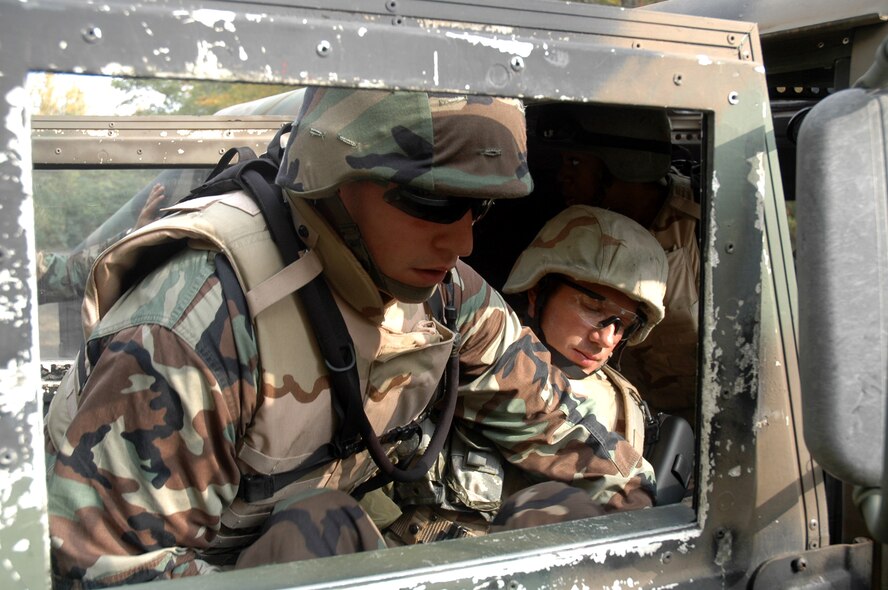 First Lt. Robert Scott pulls Master Sgt. Richard Hupp, both from Scott Air Force Base, Ill., from a "burning" vehicle during an attack on their convoy during training on a Fort Dix, N.J., range Oct. 9, 2008, as part of the Advanced Contingency Skills Training Course 09-1.   ACST is taught by the U.S. Air Force Expeditionary Center's 421st Combat Training Squadron and prepares Airmen for upcoming deployments.  (U.S. Air Force Photo/Staff Sgt. Paul R. Evans)