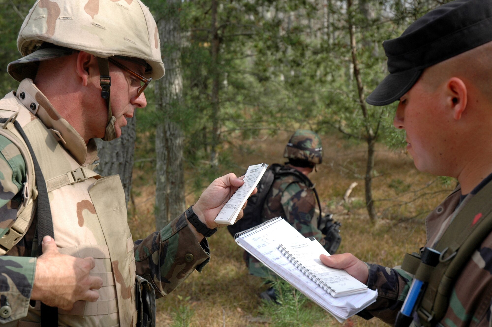 Maj. Stanely Paregien, from Scott Air Force Base, Ill., provides detection information to his contingency skills instructor, Tech. Sgt. Vincent Schyuler of the 421st Combat Training Squadron, during training for improvised explosive detection on a Fort Dix, N.J., range Oct. 8, 2008, for the Advanced Contingency Skills Training Course 09-1.  The course is taught by the U.S. Air Force Expeditionary Center's 421st CTS and prepares Airmen for upcoming deployments.  (U.S. Air Force Photo/Staff Sgt. Paul R. Evans)