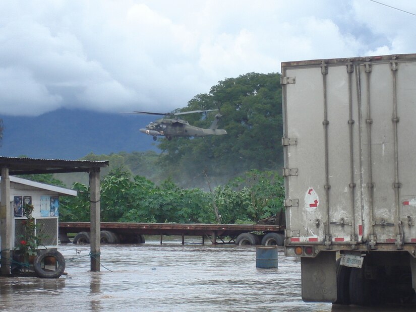 A Joint Task Force-Bravo medical evacuation helicopter flies over the flooded area in Comayagua, Honduras, Oct. 19 to assist in rescue operations in the area. JTF-Bravo crews rescued four people trapped by flood waters. (Photo by Martin Chahin)                               