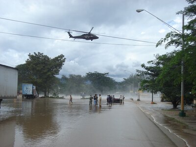 A Joint Task Force-Bravo medical evacuation helicopter flies over the flooded area in Comayagua, Honduras, Oct. 19 to assist in rescue operations in the area. JTF-Bravo crews rescued four people trapped by flood waters. (Photo by Martin Chahin)                               