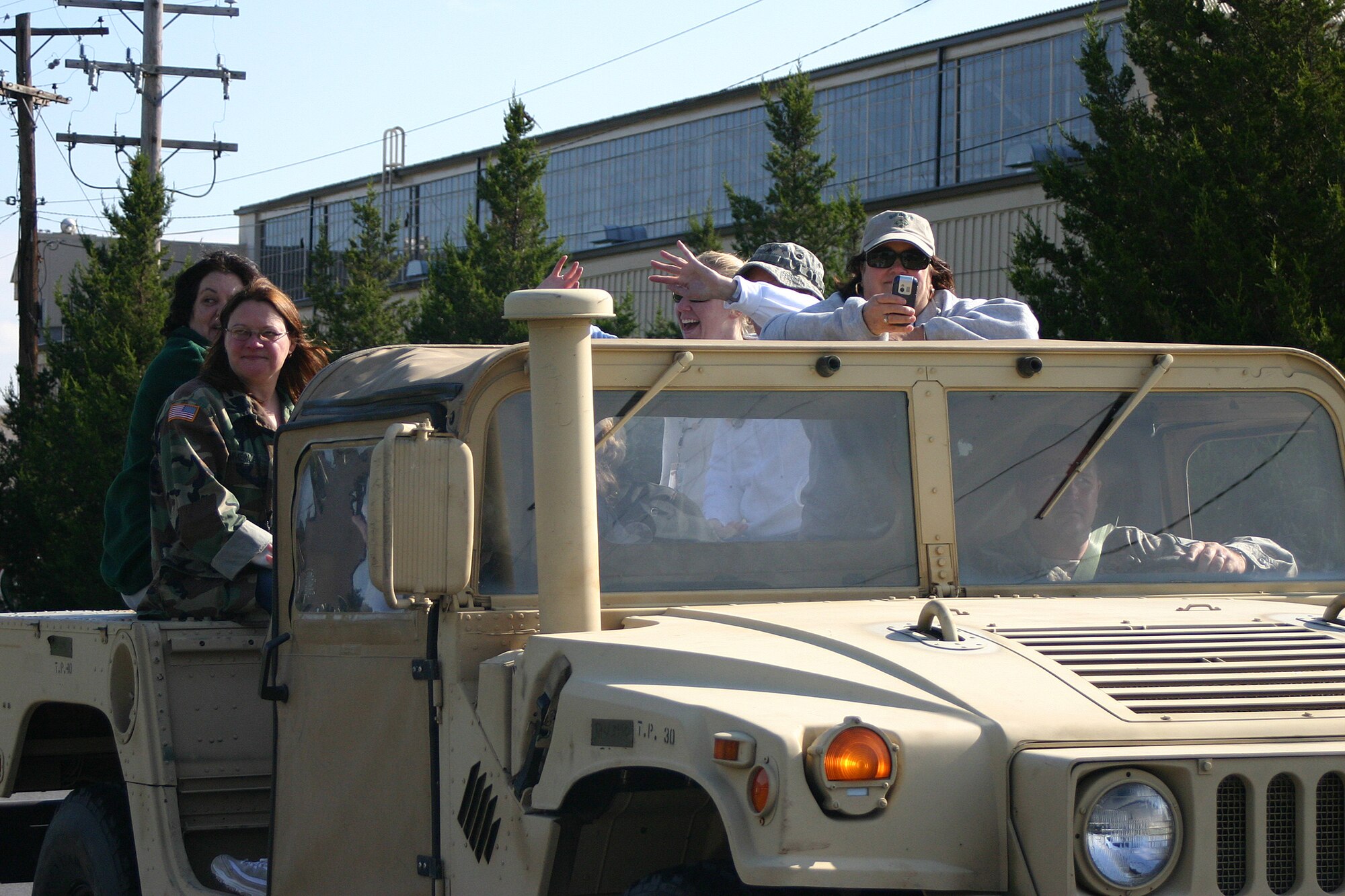 Several Gold Star Moms, mothers who have lost a son or daughter in combat, ride in a Humvee cheering for teams competing in a Ruck March held in their honor Oct. 18. More than 250 Airmen, Soldiers, Civil Air Patrol cadets and civilians competed in the second annual Gold Star Mom Ruck March here. (U.S. Air Force photo/Senior Airman Danielle Johnson)