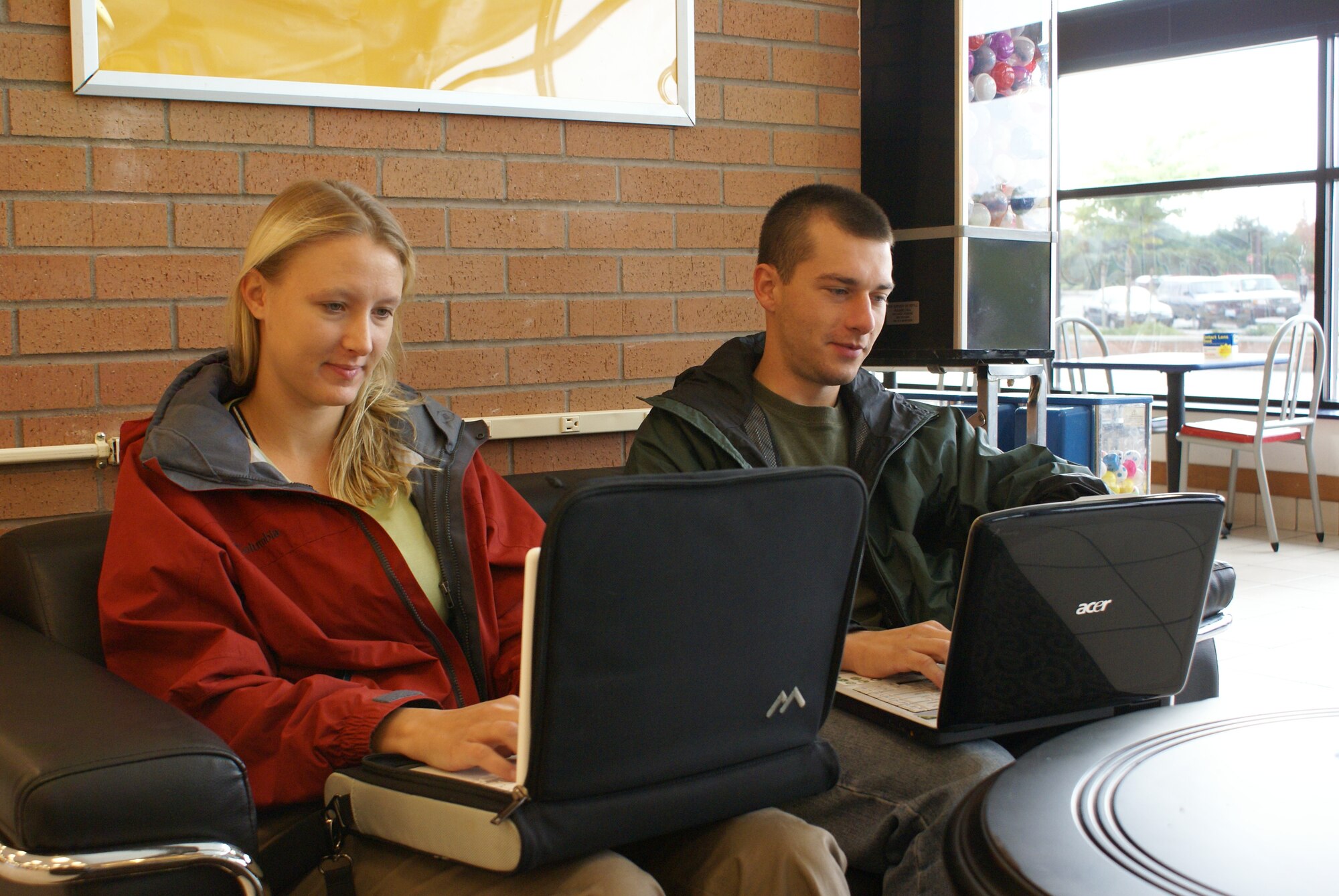 1st Lt. Patrick Knight, 4th Airlift Squadron, and his wife, Jennifer, surf the Internet Oct. 15 in the Wi-Fi lounge area of the food court inside the base exchange. (U.S. Air Force photo/Tyler Hemstreet) 
