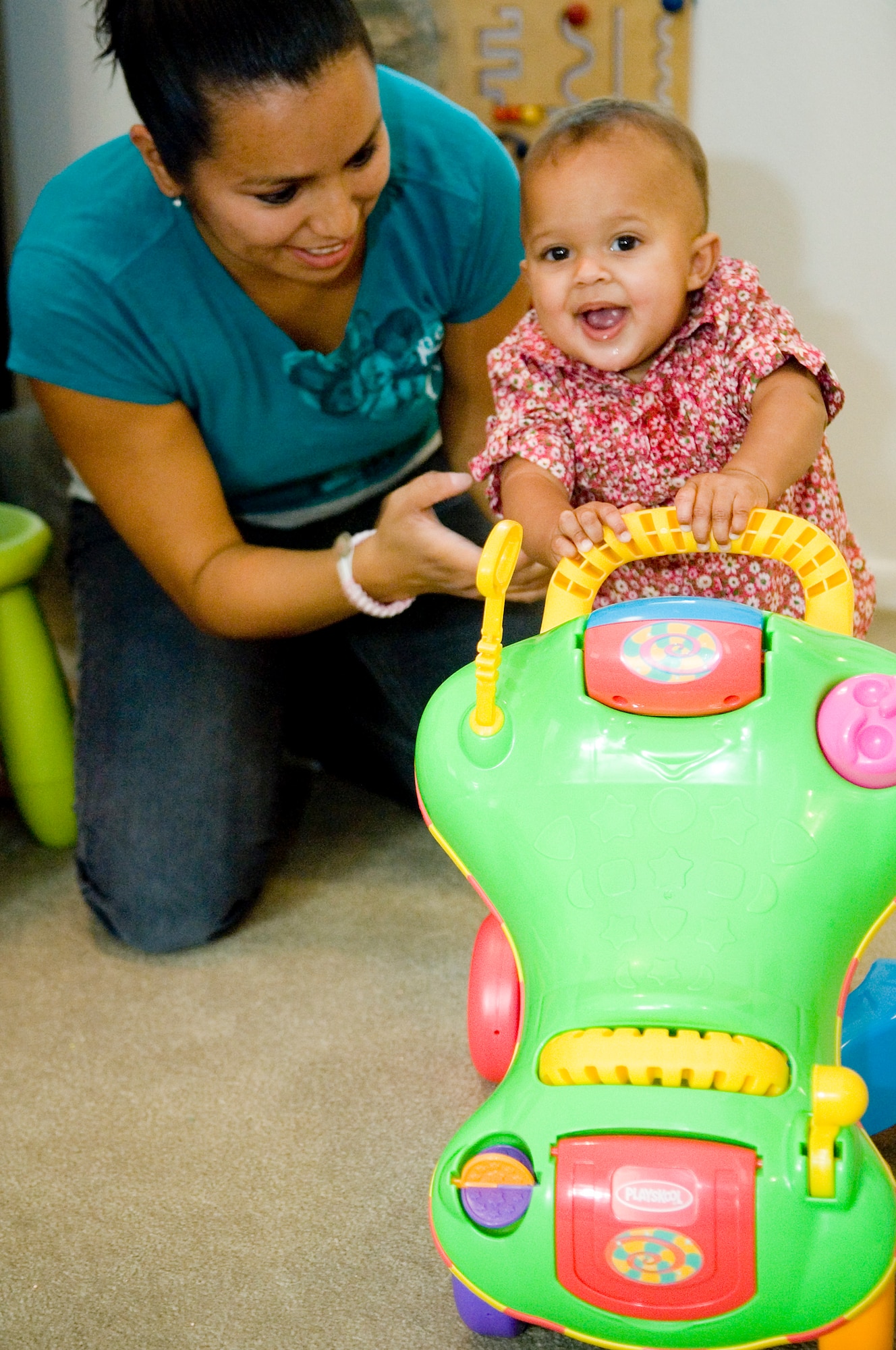 Catalina Noguez plays with 8-month-old Sophia Fisher in the living room of
her home Oct. 15. (U.S. Air Force photo/Abner Guzman)