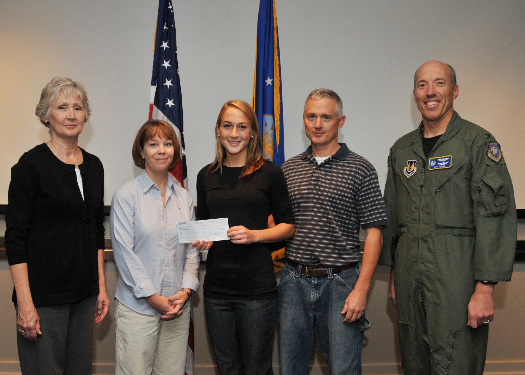 Far right, Arnold Engineering Development Center Commander Col. Art Huber presented the 2008 Air Force Club Membership Scholarship Program check for $1,000 to Brandi Besheres, center and her grandmother, Edith Besheres, and parents, Brad and Karen Besheres were on hand to witness the event. Mr. Besheres is an aviation machinist with Aerospace Testing Alliance’s instrumentation and diagnostics branch. (Photo by David Housch)