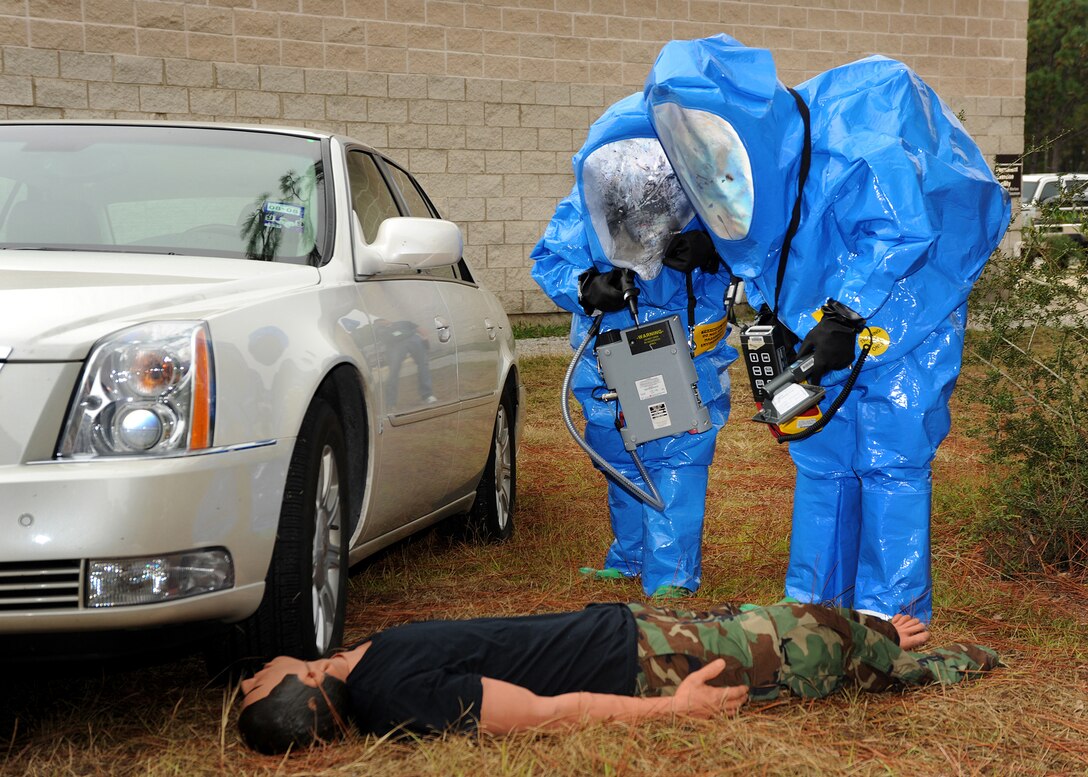Staff Sgt Amy Seaton (left), 27th Special Operations Wing, Cannon AFB, N.M., and Staff Sgt Dante Sangstack (right), 27th SOW, Cannon AFB, N.M., check the chemical levels during the Chemical, Biological, Radiological and Nuclear Challange. The excerise tests the readiness skills of the teams in a series of timed events.