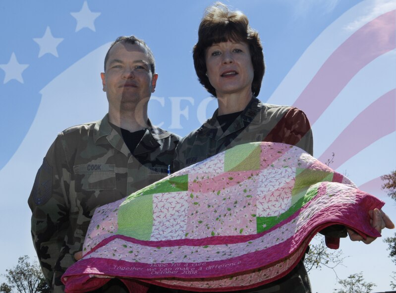 MOODY AIR FORCE BASE, Ga. – Maj. Sheri Webb, 23rd Medical Group (right), and Senior Master Sgt. Darrell Cook, 23rd Communications Squadron, contribute to the Combined Federal Campaign effort Oct. 16 here. Major Webb created a quilt for the CFC to help encourage Airmen to make donations to various charities. (U.S. Air Force photo illustration by Senior Airman Javier Cruz)